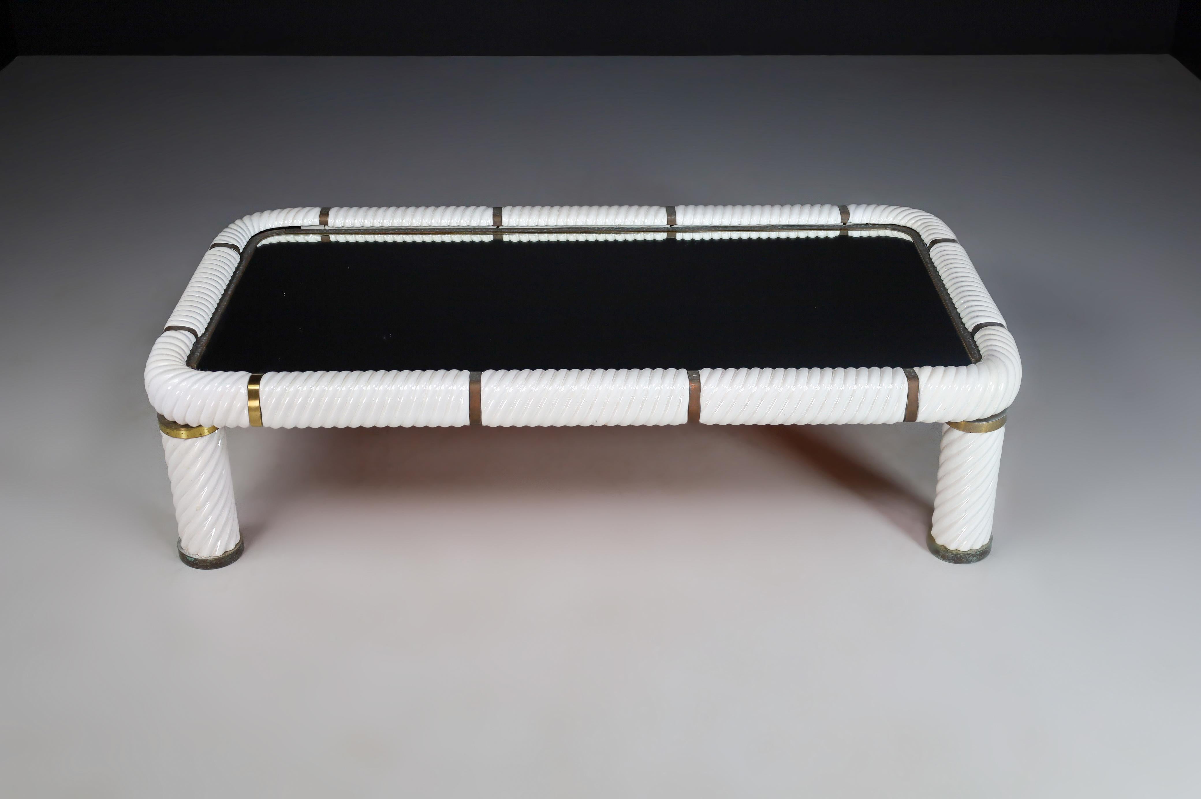 Stunning Tommaso barbi white ceramic and brass coffee table made and designed in Italy 1970s .This table features one of Barbi's signature techniques, which is porcelain in a spiral form to give this table it's absolute stunning appearance. This