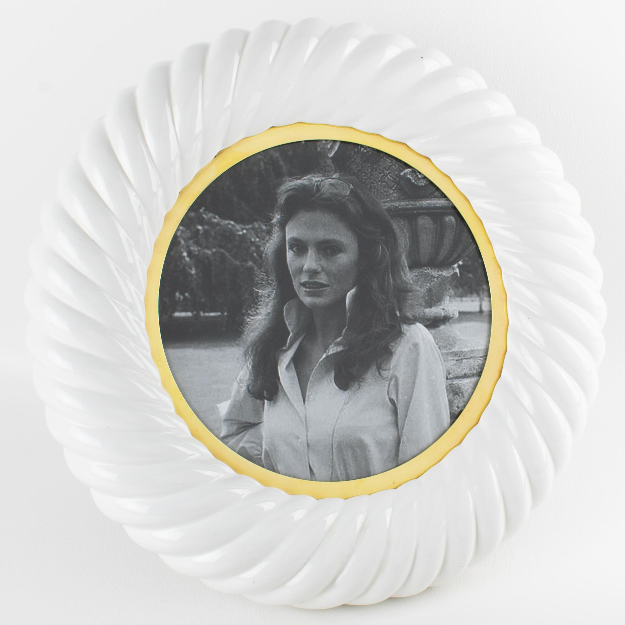 A rare and striking example of Italian design, this outstanding Tommaso Barbi picture frame—expertly crafted circa 1970—is a sculptural piece of art in its own right. The substantial body is formed from white glazed ceramic, braided into an elegant