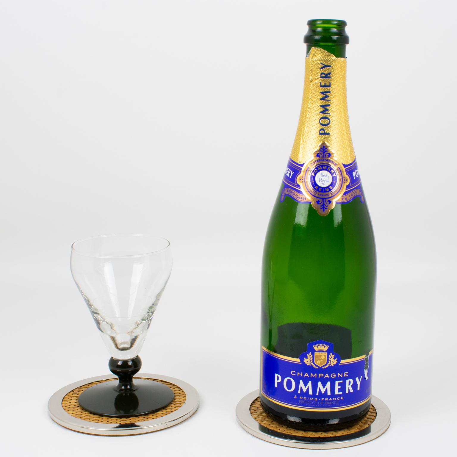 Tommaso Barbi crafted this lovely Mid-Century modernist barware set of two coasters in Italy in the 1970s. The rounded shape boasts a chromed metal stepped framing complemented by braided genuine wicker, rattan, or bamboo. The bottom side has been