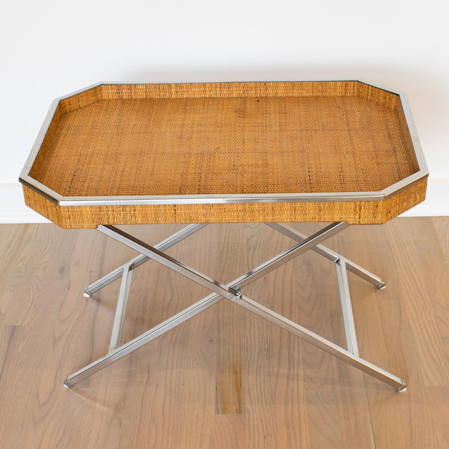 Tommaso Barbi designed this elegant large barware folding tray table in Italy in the 1970s. The rectangular butler shape boasts a chromed metal raised gallery and genuine rattan cane-work or wicker. The table has a chrome metal folding X-stand. The
