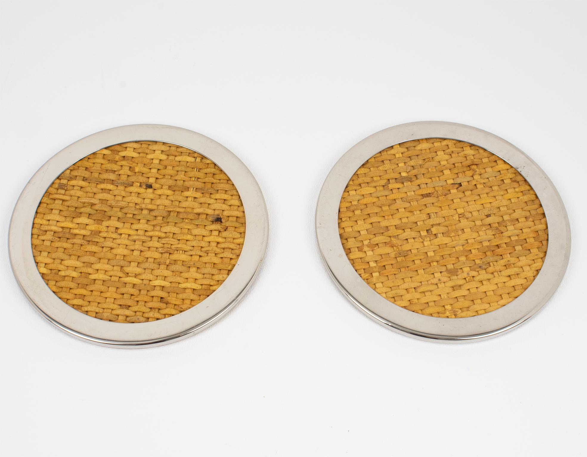 Tommaso Barbi crafted this lovely Mid-Century modernist barware set of two coasters in Italy in the 1970s. The rounded shape boasts a chromed metal stepped framing complemented by braided genuine wicker, rattan, or bamboo. The bottom side has been