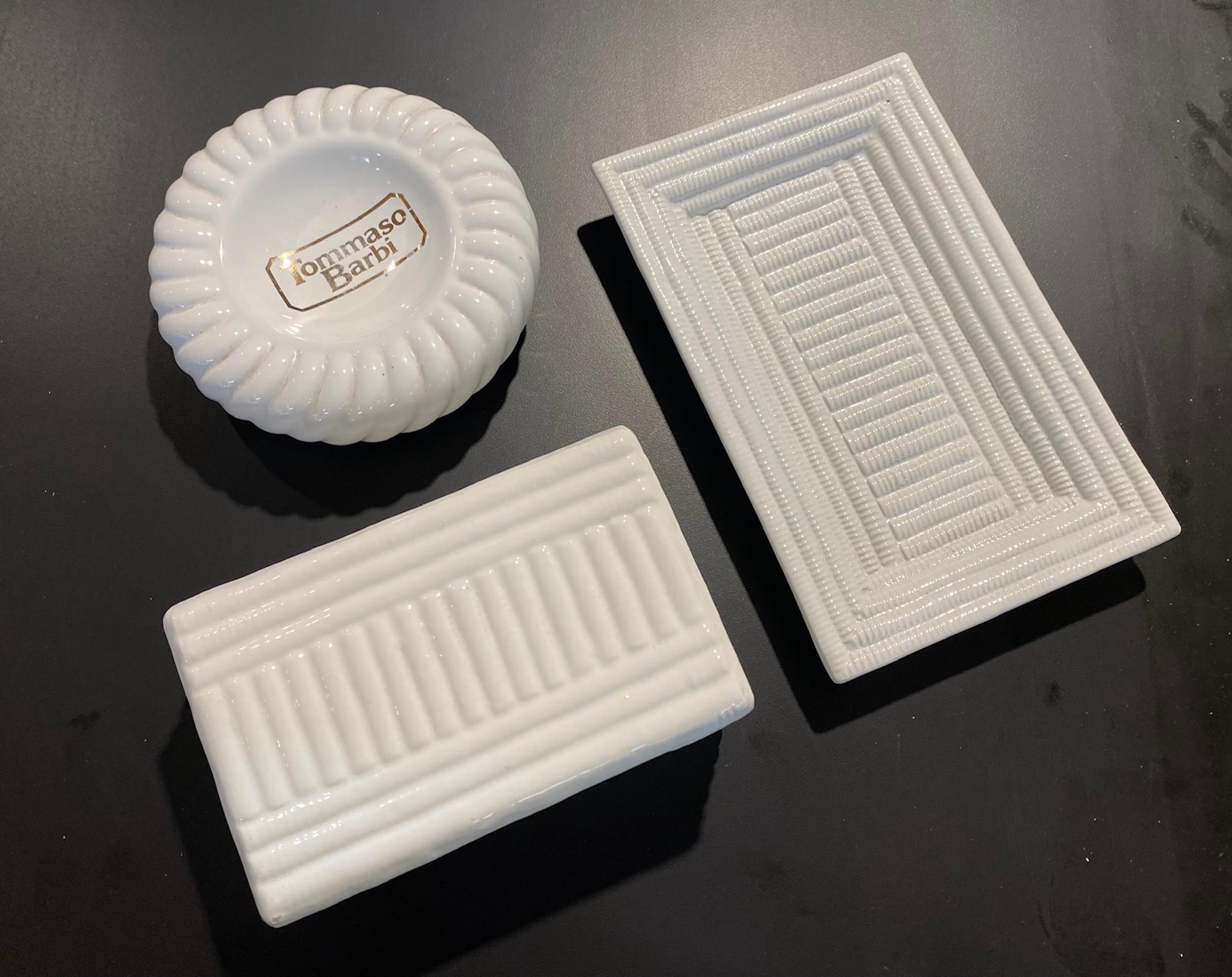 Tommaso Barbi group of 3 1980s ceramic smoking objects of 1 box and 2 ashtrays.
All signed in white glaze B. Ceramiche.
Box.        6.88 W   4.25 D   2.75 H
Round     6.25 D   1.75 H 
Tray.        9.25 L.    6 W.   1.25 H