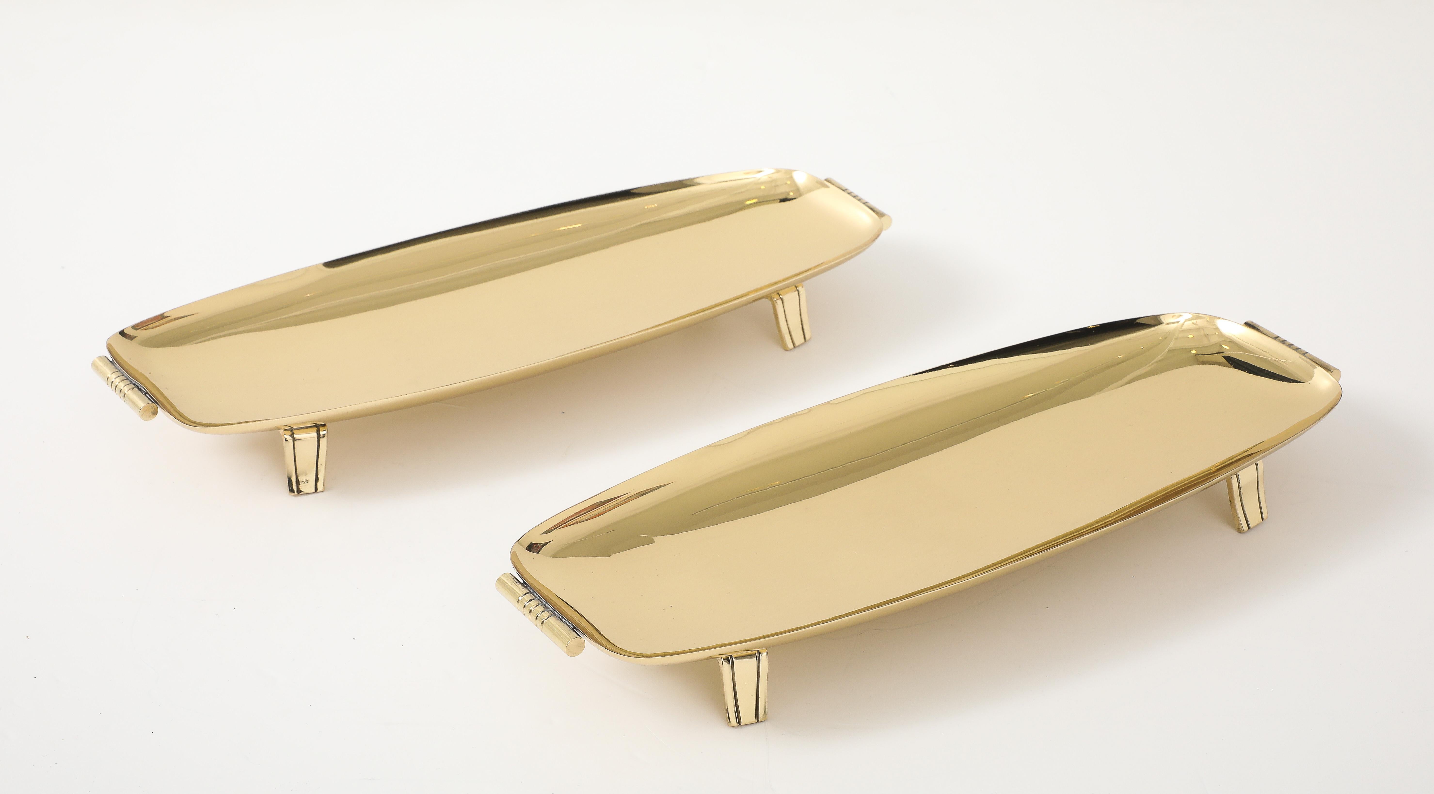 Pair of elegant solid brass oblong serving/bread trays with brass bar and engraved feet. Stamped