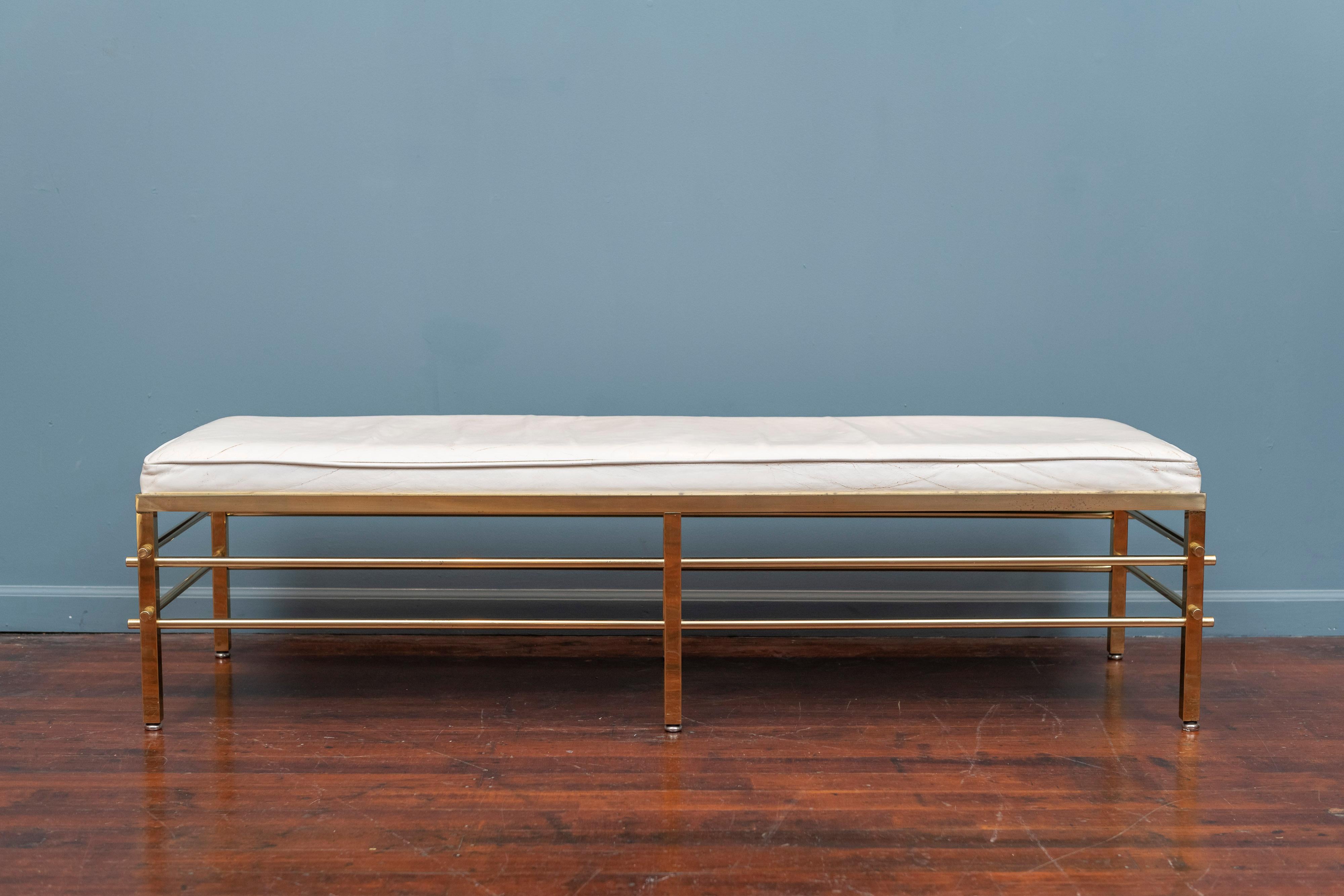 Tommi Parzinger design bench for Parzinger Originals, N.Y. Upholstered in what appears to be the original white leather on a brass tubular studded frame. A rare design made with high quality construction and attention to detail,