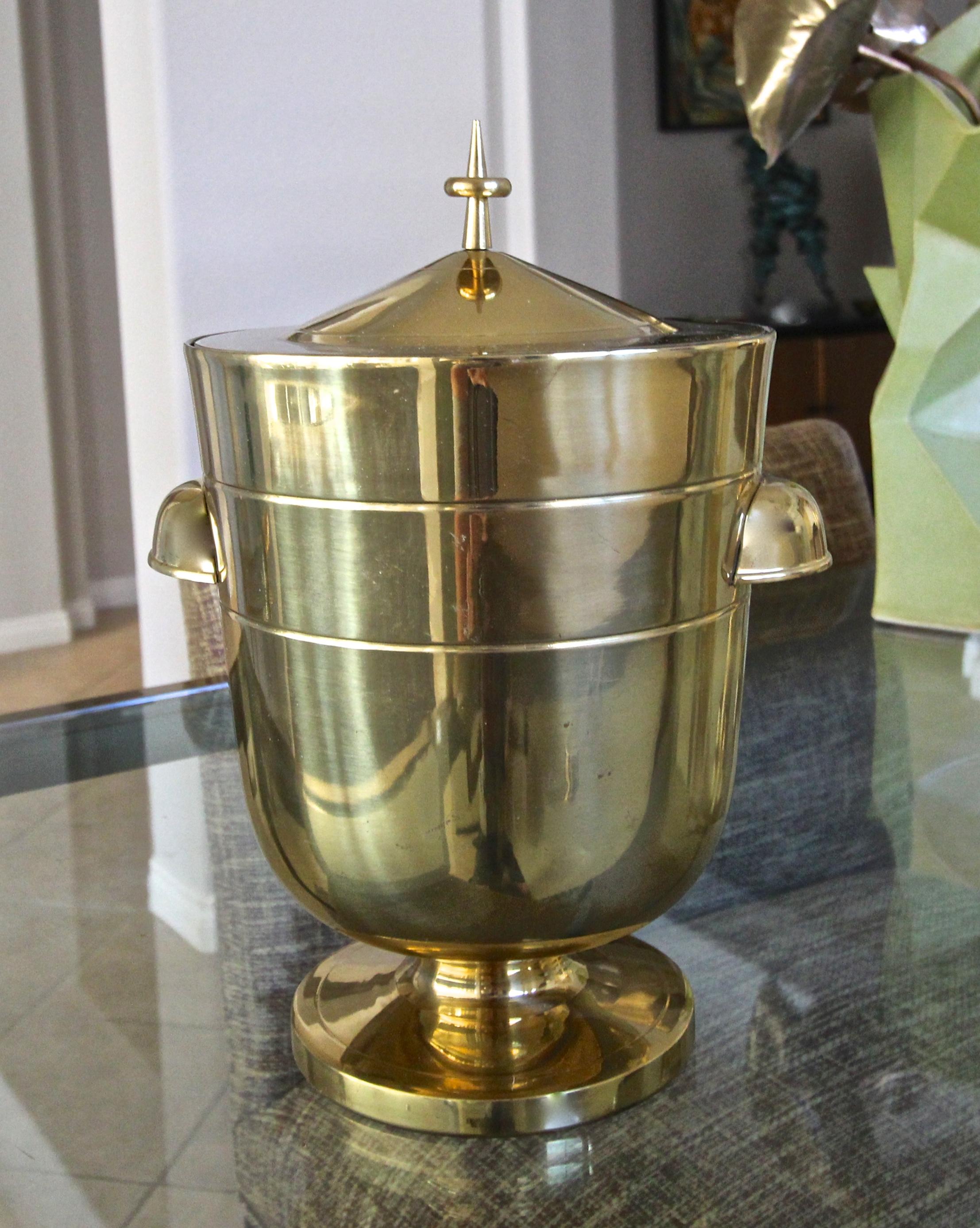 A fine lacquered brass lidded ice bucket or champagne cooler designed by Tommi Parzinger, including ice tongs. The ice bucket is in original almost new untouched condition. Stamped 