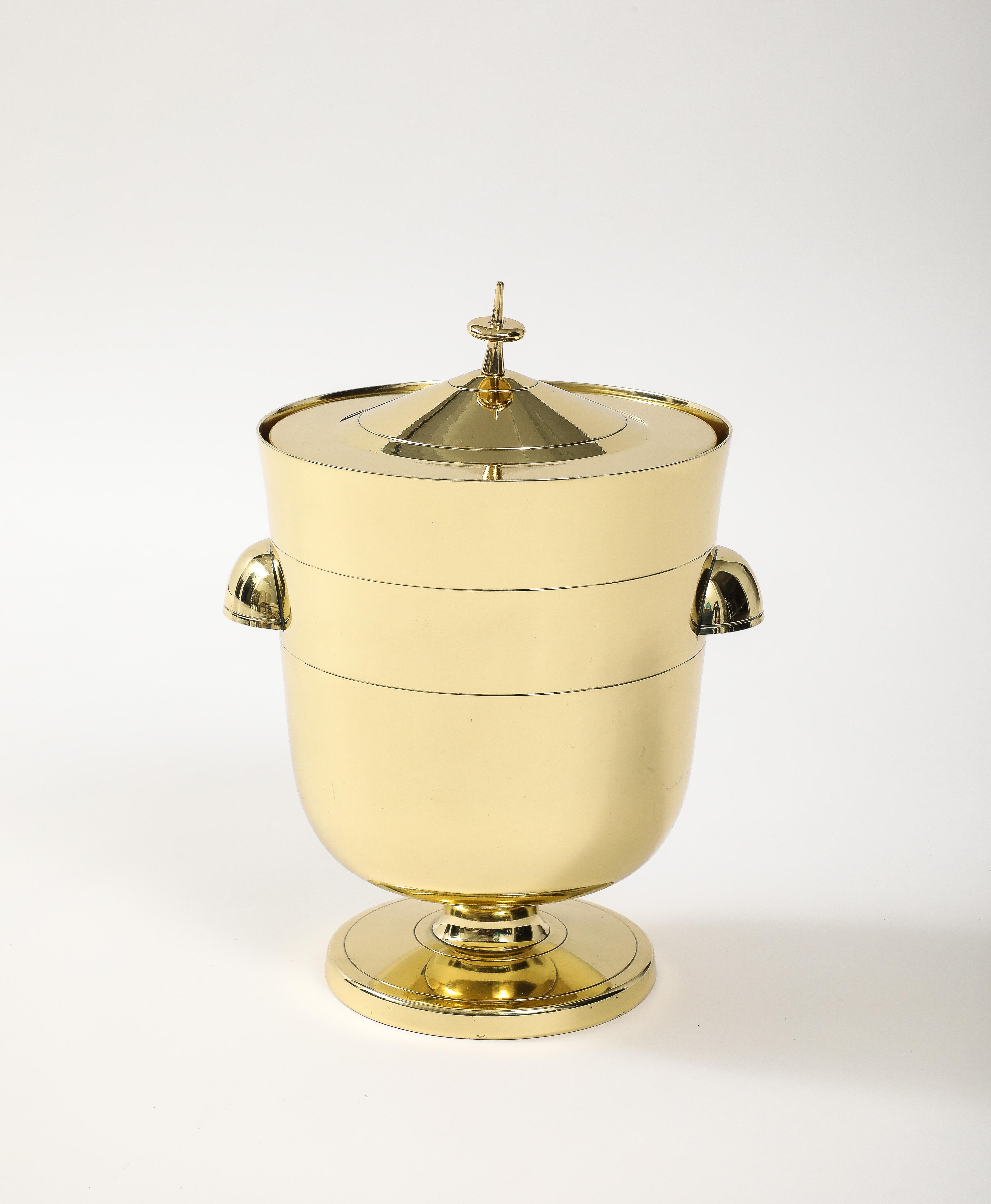 Tommi Parzinger modernist brass ice bucket featuring a mercury glass liner and a finial top on lid. Professionally polished and lacquered.