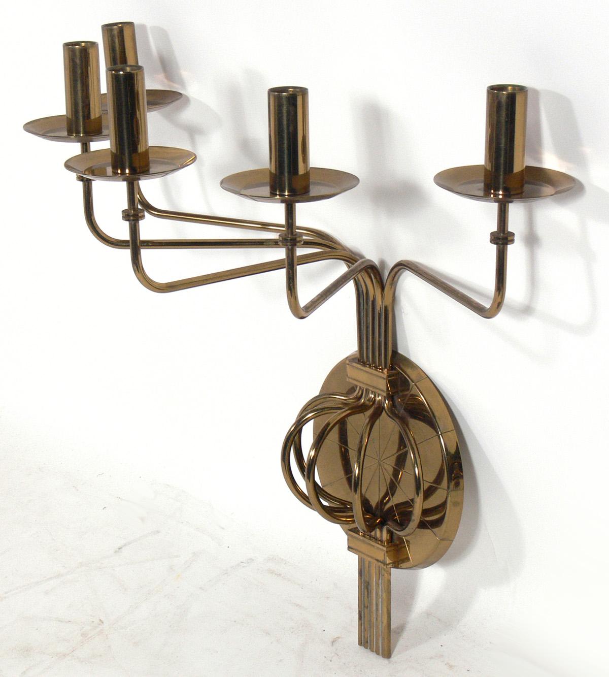 Sculptural brass sconces, designed by Tommi Parzinger for Dorlyn Silversmiths, American, circa 1950s. The sconce on the left measures 10