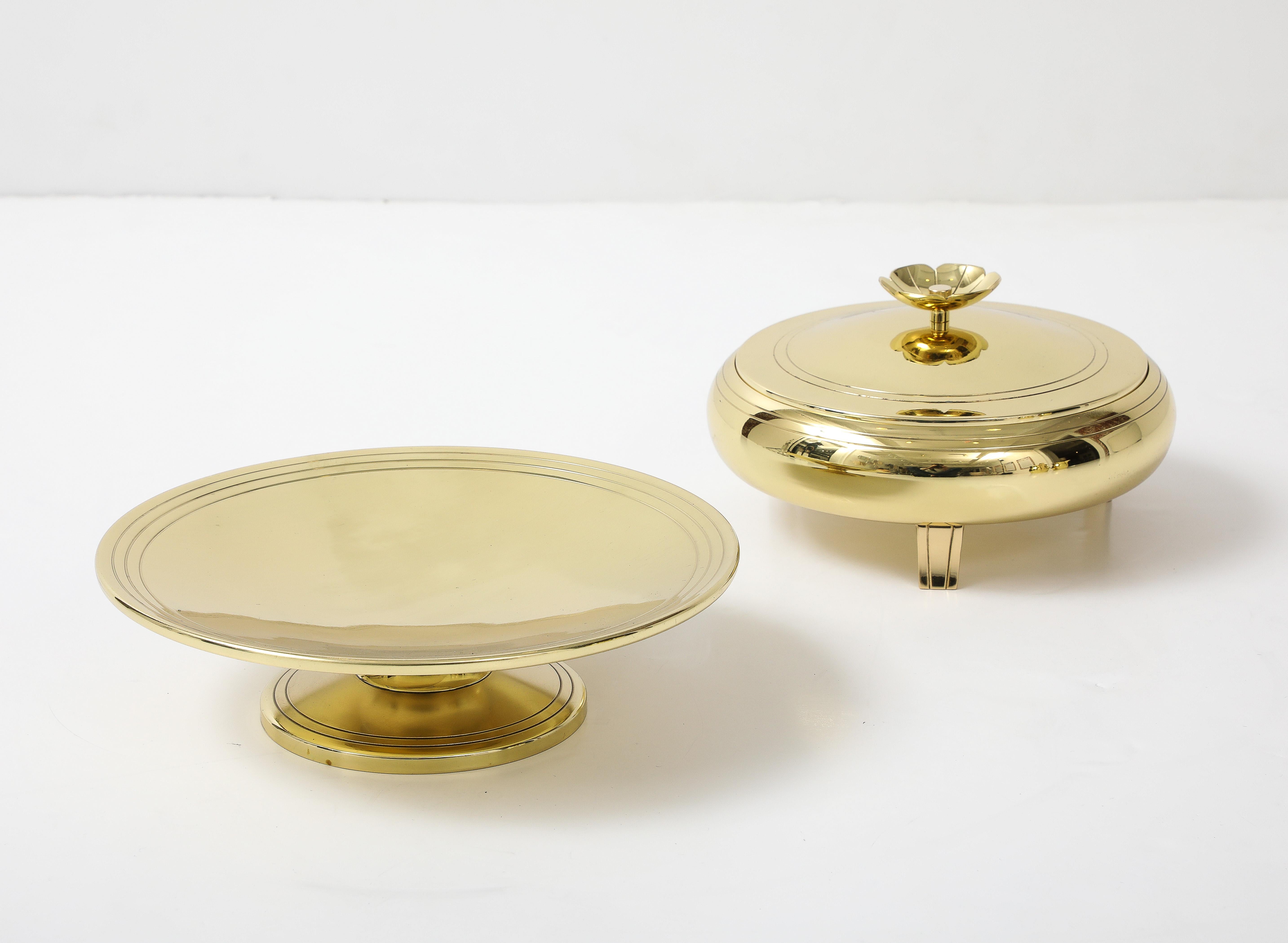 Set of 2 brass serving pieces designed by Tommi Parzinger featuring a brass compote and a brass covered dish with a divided glass insert. Each stamped.

