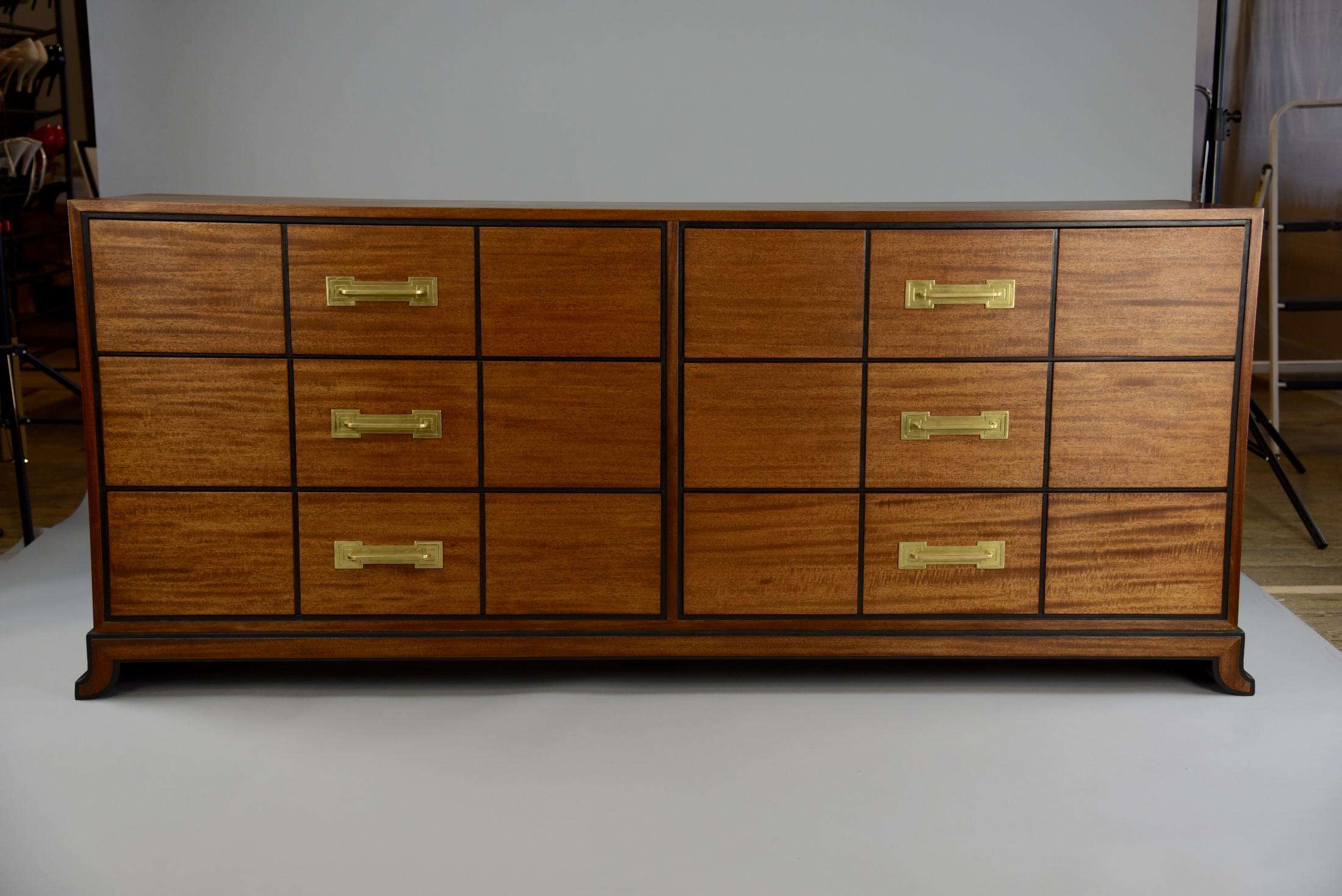 Six drawer low chest, designed by Tommi Parzinger, circa 1948. Produced in Boston, Massachusetts by Charak Furniture Company. Charak, was at one point, one of the finest furniture makers in the country. This cabinet features solid mahogany and