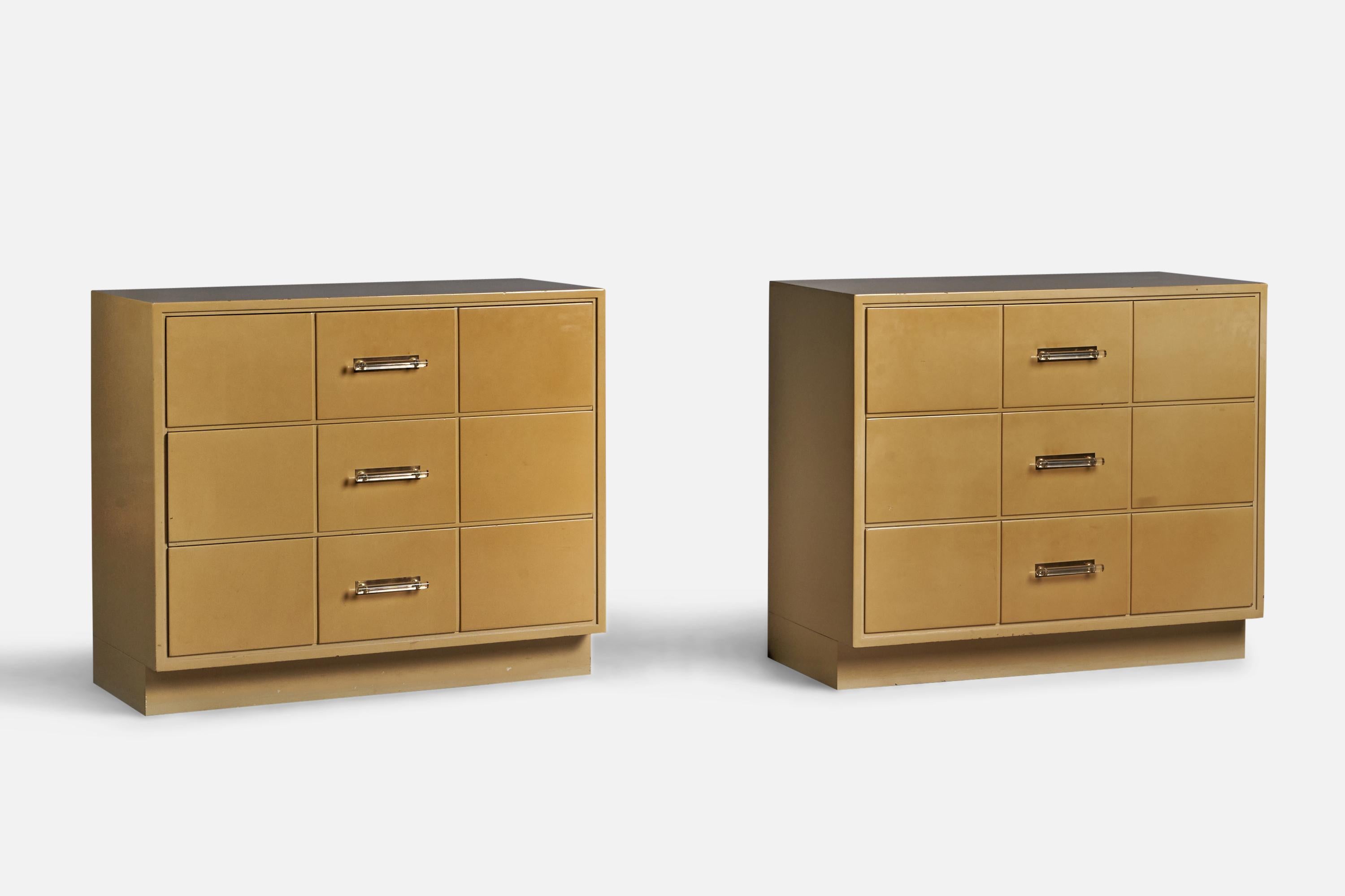 A pair of beige-lacquered wood, brass and lucite chest of drawers, designed by Tommi Parzinger and produced by Charak Modern, USA, 1950s.
