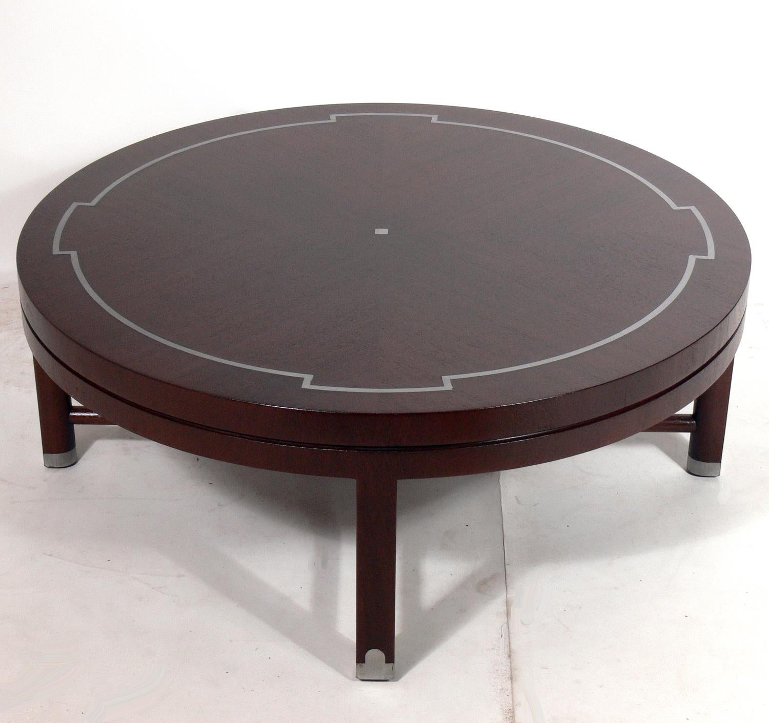 Elegant coffee table, designed by Tommi Parzinger, American, circa 1950s. It is constructed of mahogany and inlaid pewter. It has been refinished in a deep medium brown color.