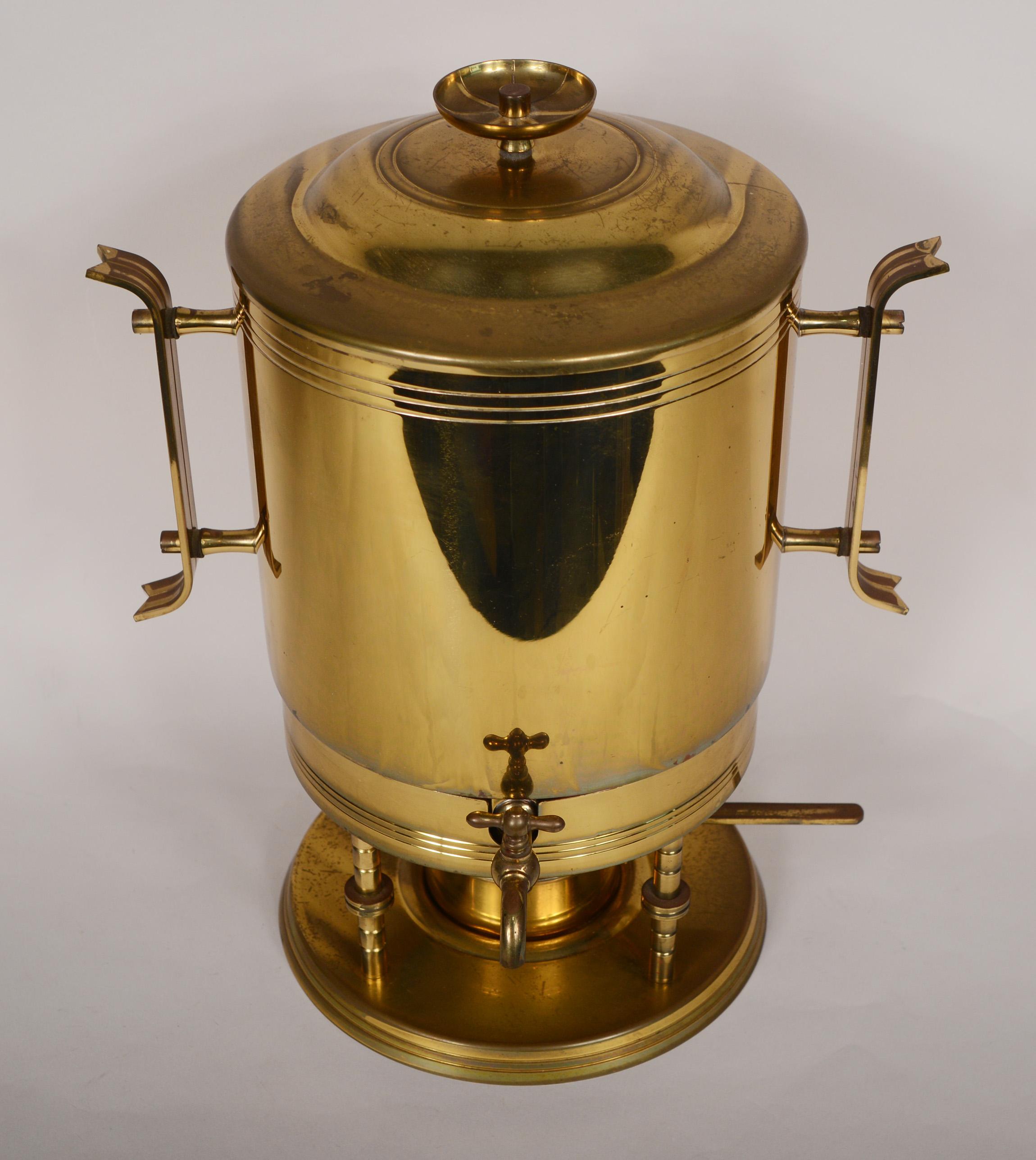 Coffee or hot water urn designed by Tommi Parzinger and made by Dorlyn Silversmiths. This consists of the urn and stand with a burner and snuffer. This has the original finish. There is some discoloration and oxidation to the brass. The stand for