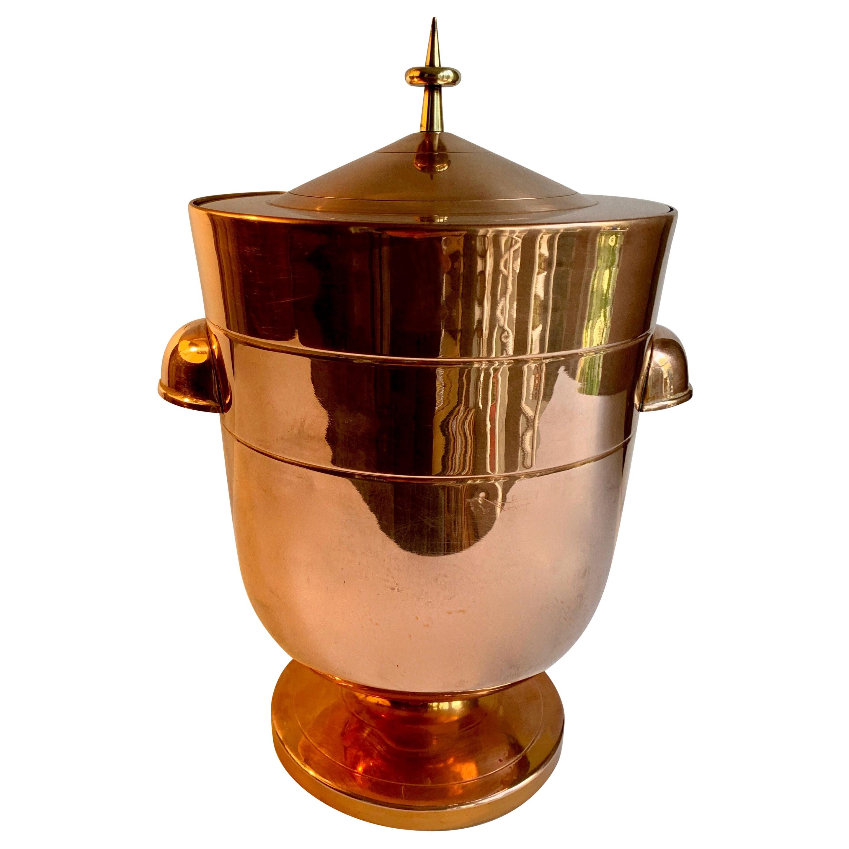 A wonderful Mid-Century Modern ice bucket by Iconic desinger, Tommi Parzinger. The piece has been freshly polished - a statement piece for any bar with a lovely brass finial atop. A must have for any midcentury bar.