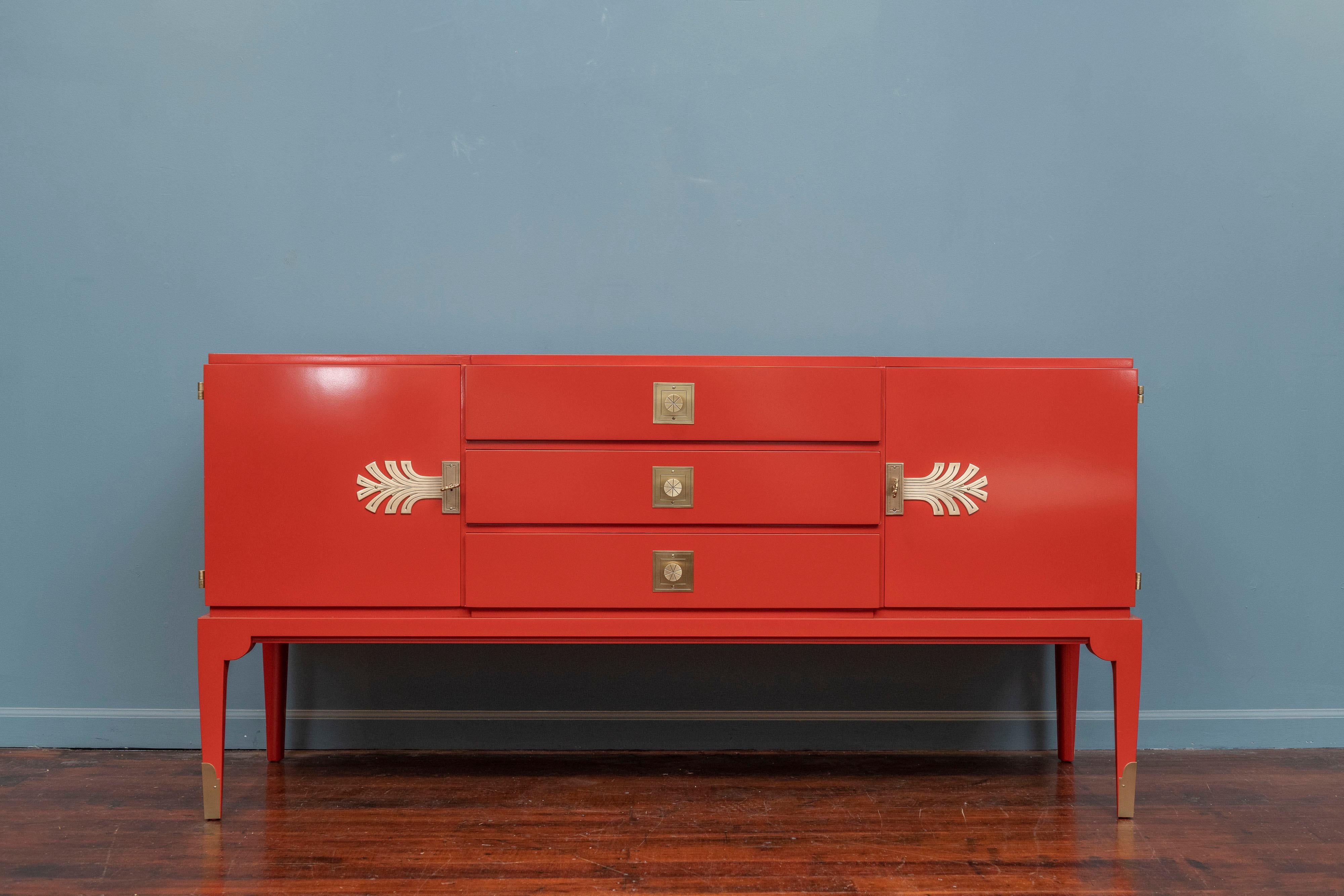 Tommi Parzinger design Chinese red lacquer credenza with polished brass mounted hardware. 
High quality construction and attention to details, newly lacquered in the original color scheme, labeled.