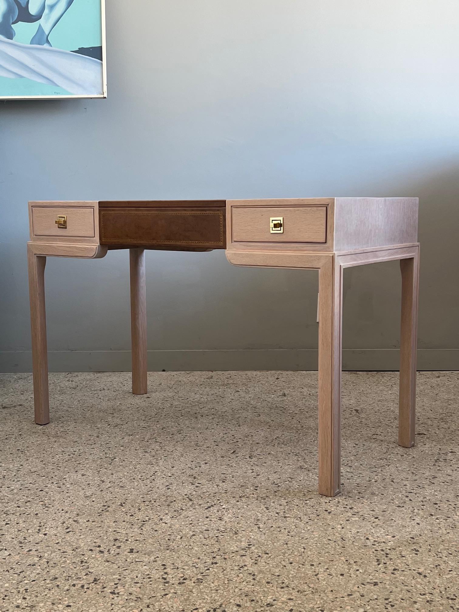 Quirky and elegant Tommi Parzinger desk for Charak Modern, 1949. From the original owner, with a new pickled oak finish. Original leather top, original hardware, retaining the original organizer in the drawer. Copy of original receipt provided.