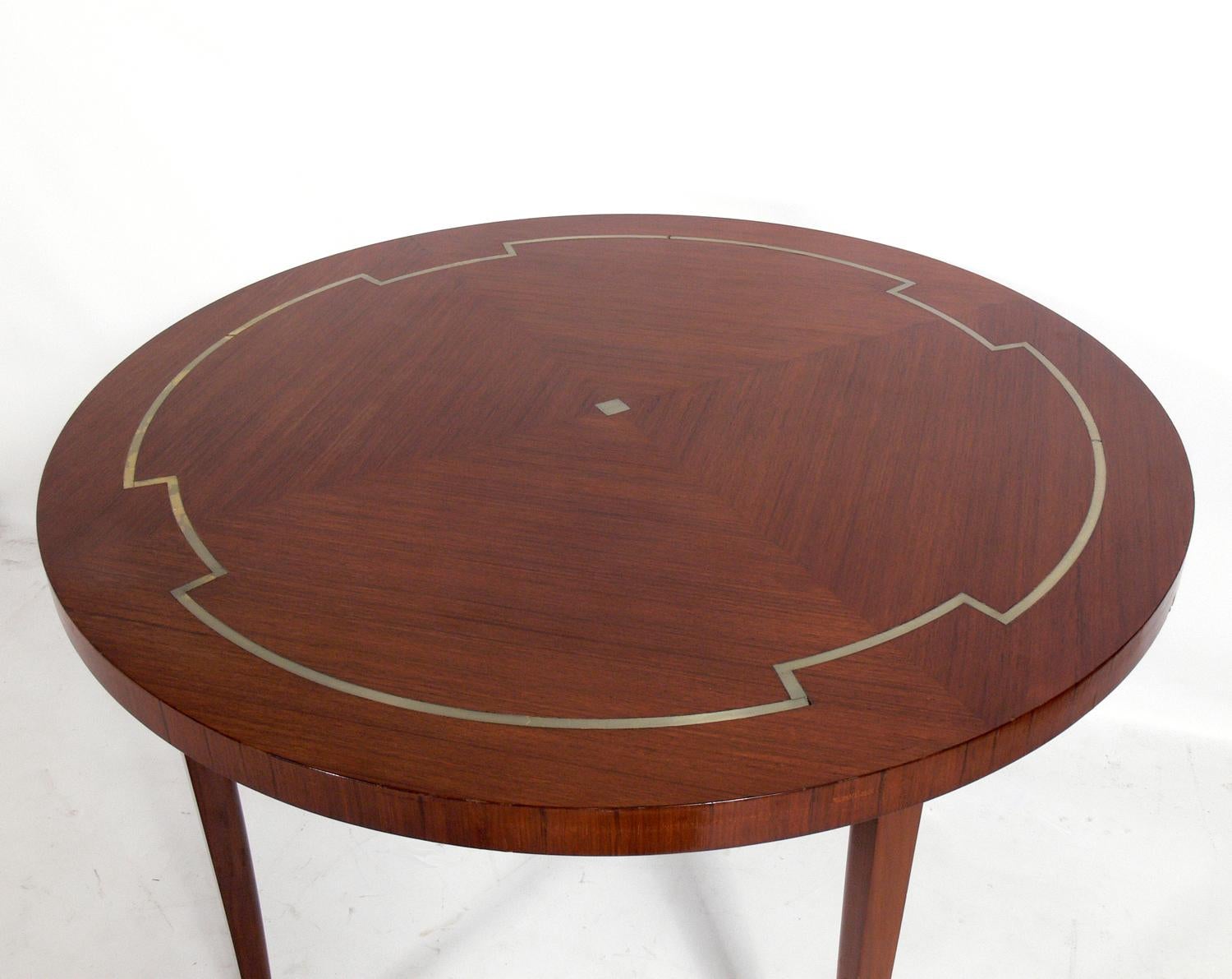 Elegant dining table, designed by Tommi Parzinger for Parzinger originals, circa 1960s. This table is currently being refinished and can be completed in your choice of finish color. It is a versatile size and can be used as a small dining table for