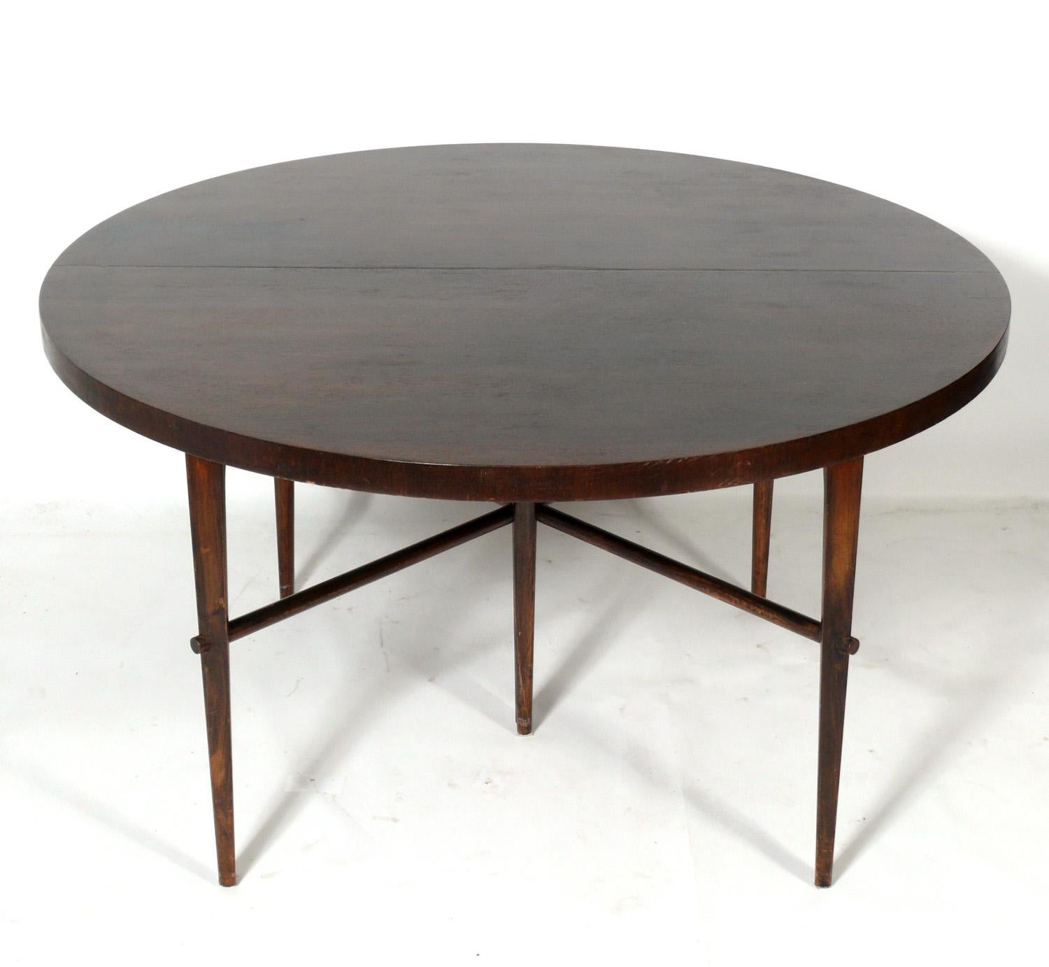 Elegant mid century dining table, designed by Tommi Parzinger, American, circa 1950s. This table is currently being refinished and can be completed in your choice of color. The price noted includes refinishing in your choice of color. It currently