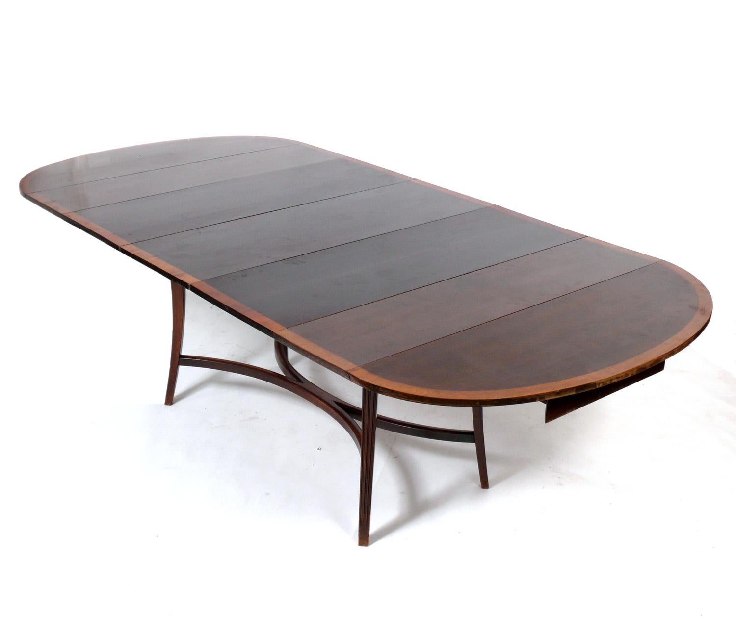 Elegant dining table, designed by Tommi Parzinger for Charak Modern, American, circa 1950s. This table is currently being refinished and can be completed in your choice of finish color. The price noted INCLUDES refinishing in your choice of color.