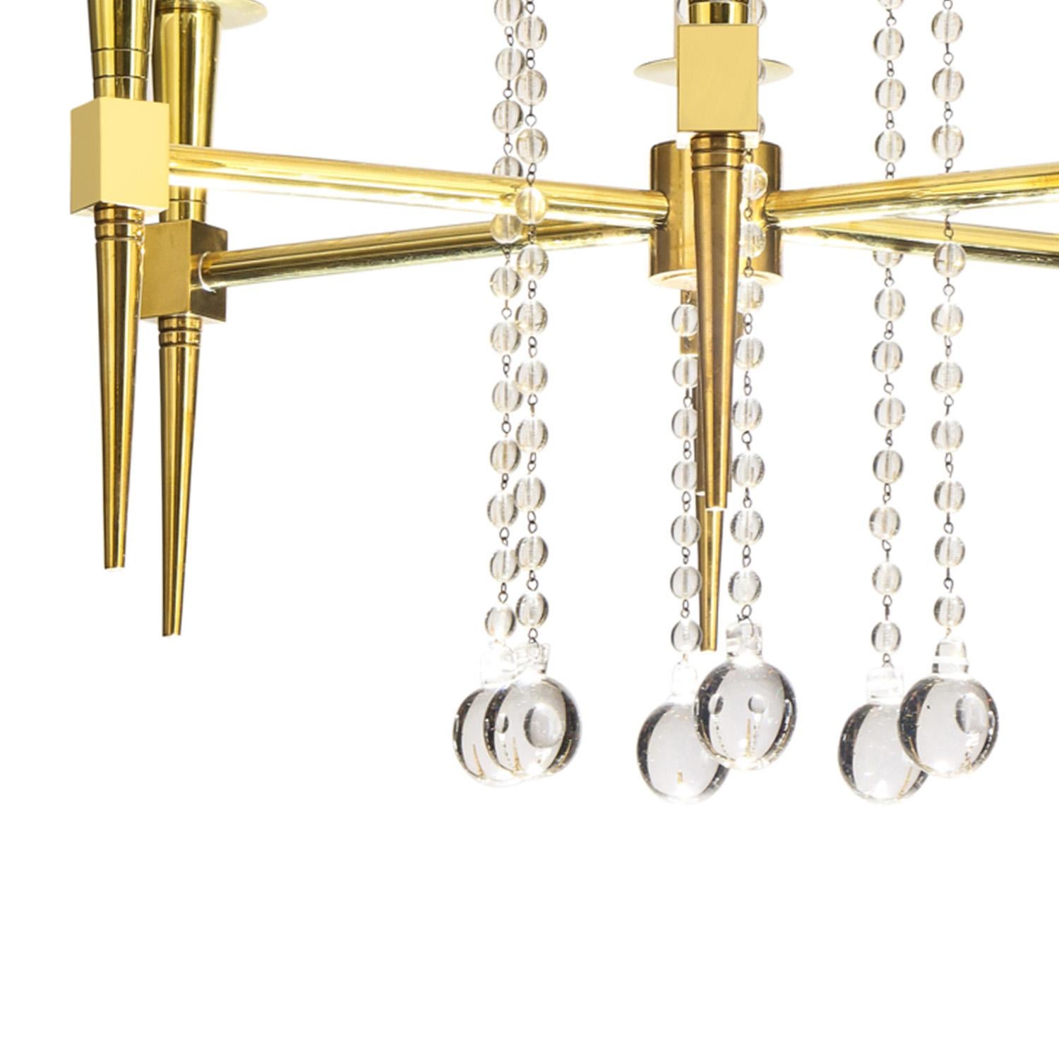 Hand-Crafted Tommi Parzinger Elegant 6 Arm Chandelier in Brass and Crystal 1950s For Sale