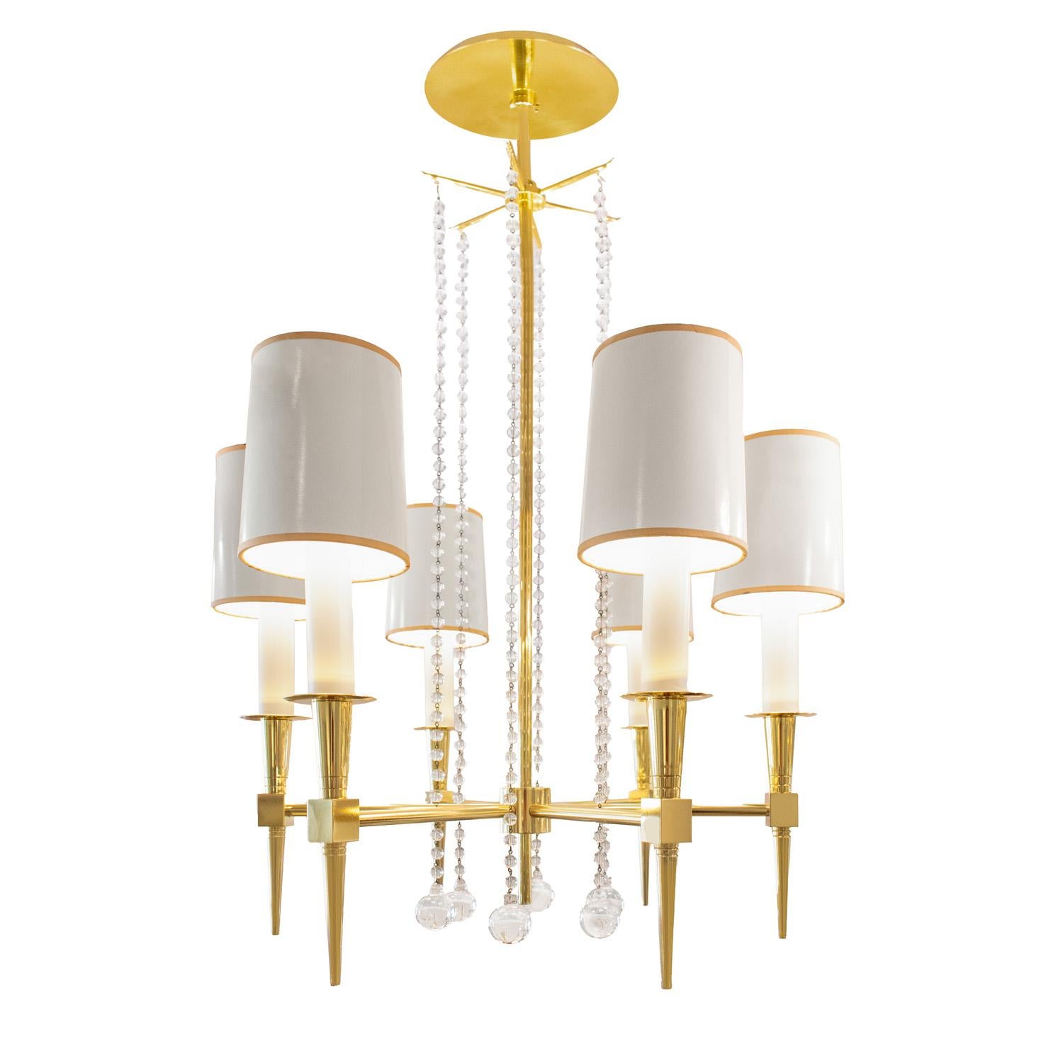 Beautifully crafted 6 arm chandelier model no 1 in brass with suspended crystal beads by Tommi Parzinger for Parzinger Originals, American 1950's. Includes original shades. Brass has been professionally polished and lacquered.  Newly rewired.  This