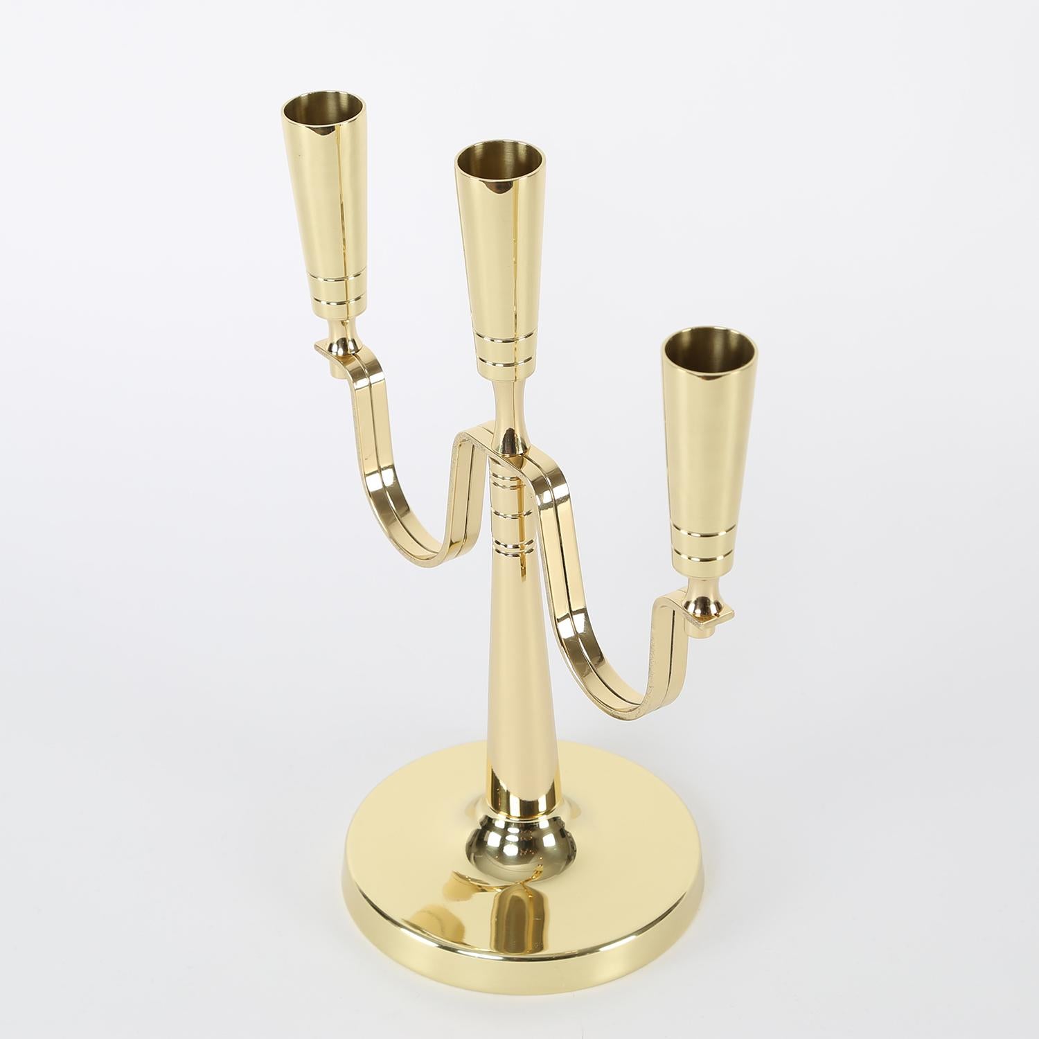 Elegant engraved candelabrum in polished brass holding 3 candles by Tommi Parzinger for Dorlyn Silversmiths, American 1950's.