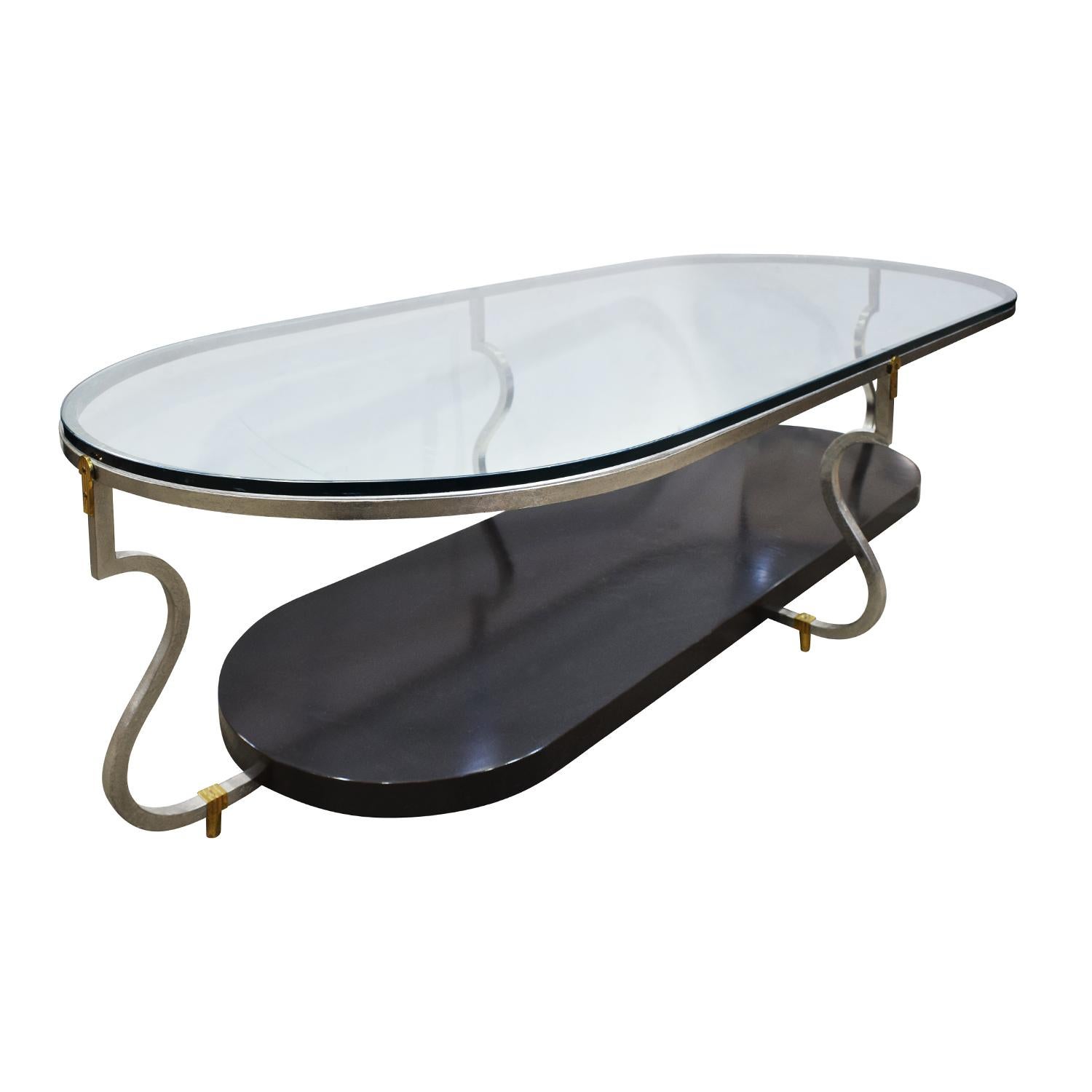 Coffee table No. 222 in silver leaf over steel with brass accents, black lacquer base and inset glass top with by Tommi Parzinger for Parzinger Originals, American, 1960s. This coffee table is extremely elegant and a fine example of Parzinger’s