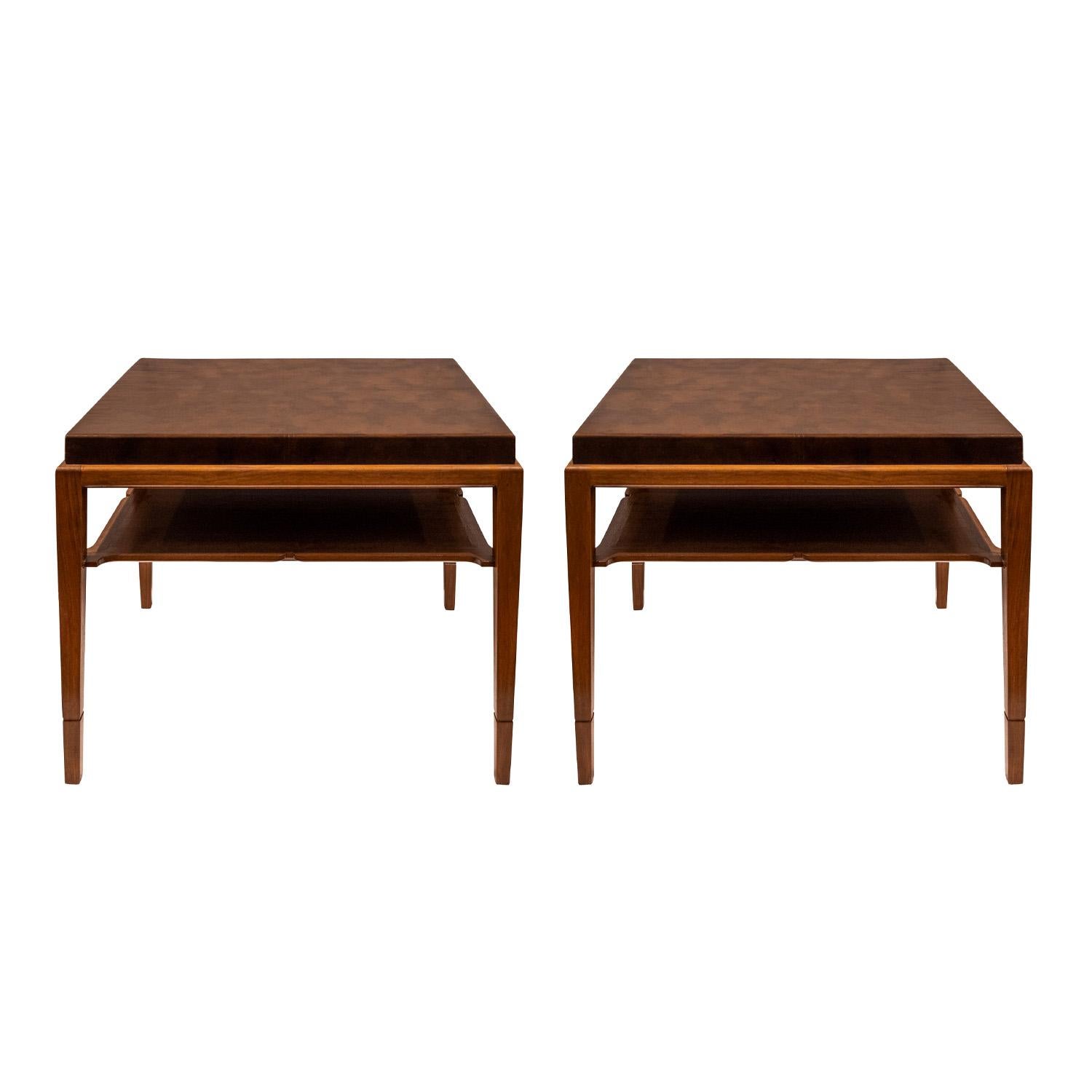 Pair of highly refined end tables model 210 in mahogany with shelves and custom original tortoishell leather tops by Tommi Parzinger for Charak Modern, American 1940's.  As with all Parzinger pieces, these exude attention to detail and superb
