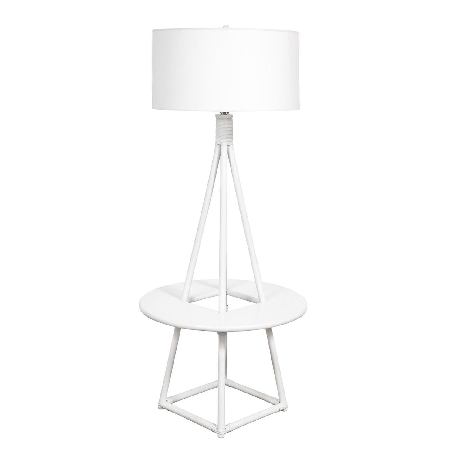 Elegant white lacquered floor lamp with incorporated white laminate table by Tommi Parzinger for Willow and Reed, American 1950’s. Willow and Reed designed furniture ideal for enclosed porches or outdoor areas not exposed to the elements. This