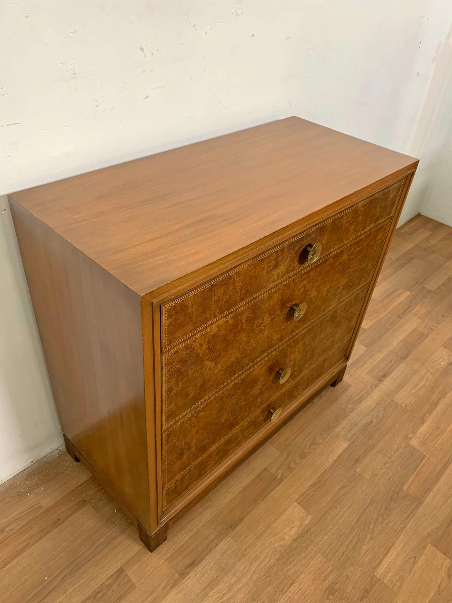 Chest of drawers designed by Tommi Parzinger for Charak Modern, ca. 1950s. Embossed leather drawer fronts with cast bronze hardware.