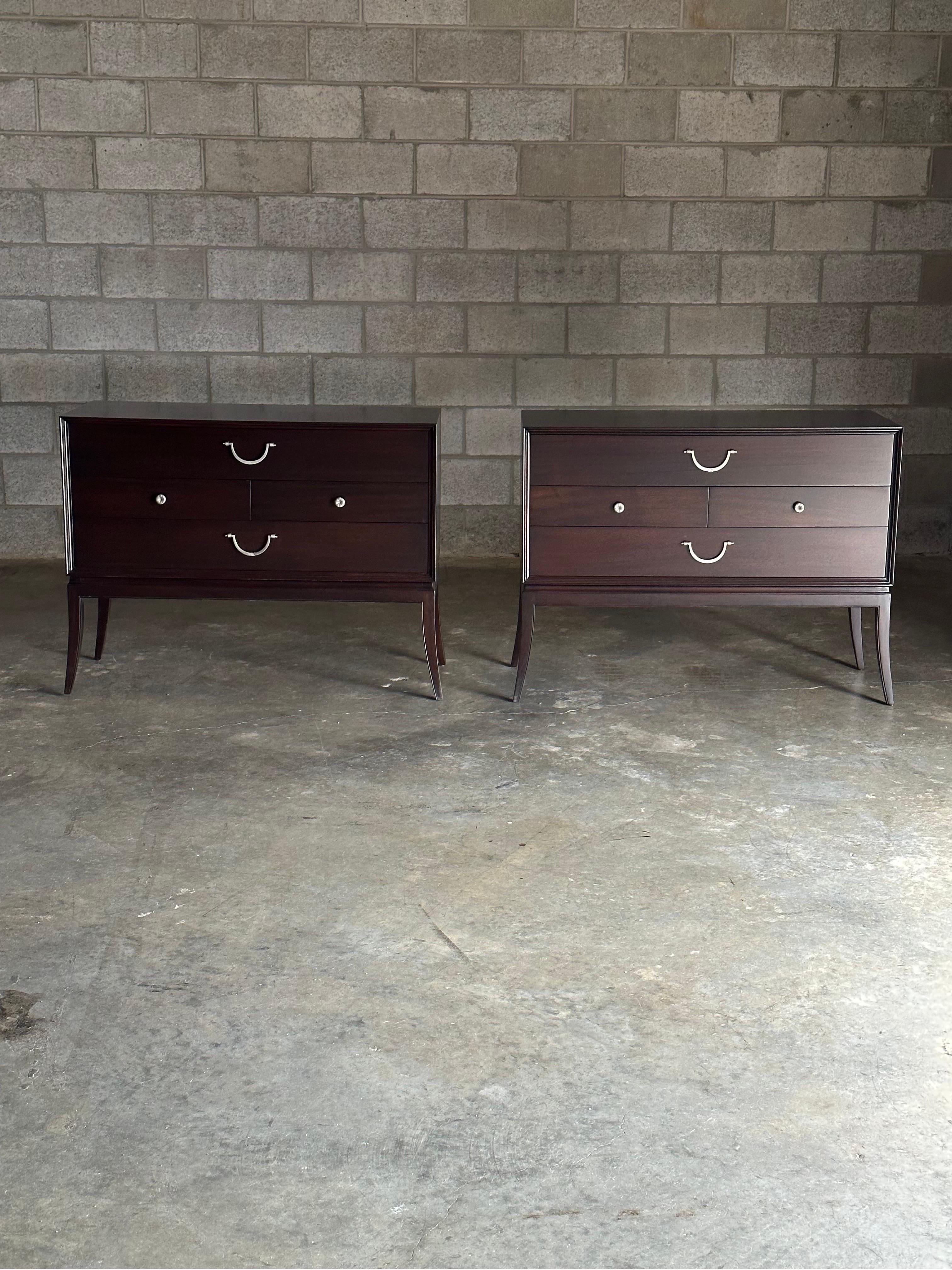 An elegant and rare pair of chests/ commodes designed by Tommi Parzinger for Charak Modern. Each chest features two large drawers and two half drawers, finished in an elegant mahogany case with exceptional hardware, resting above klismo or saber