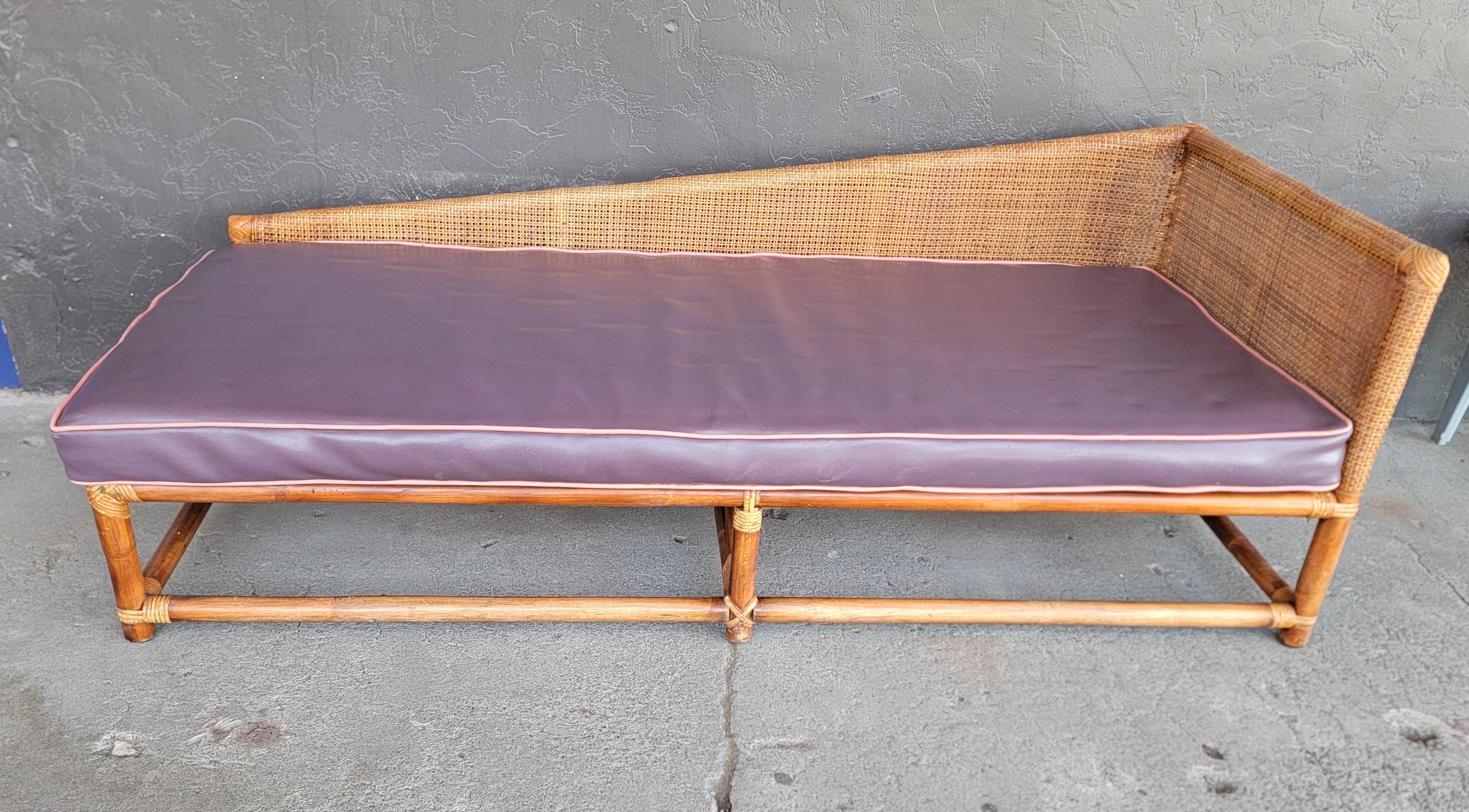 A scarce bamboo and cane chaise / daybed attributed to Tommi Parzinger for Willow and Reed. Circa. 1950's. Retains Willow & Reed label. Beautiful geometric profile to design. Original finish in very good vintage condition. Metal seat supports