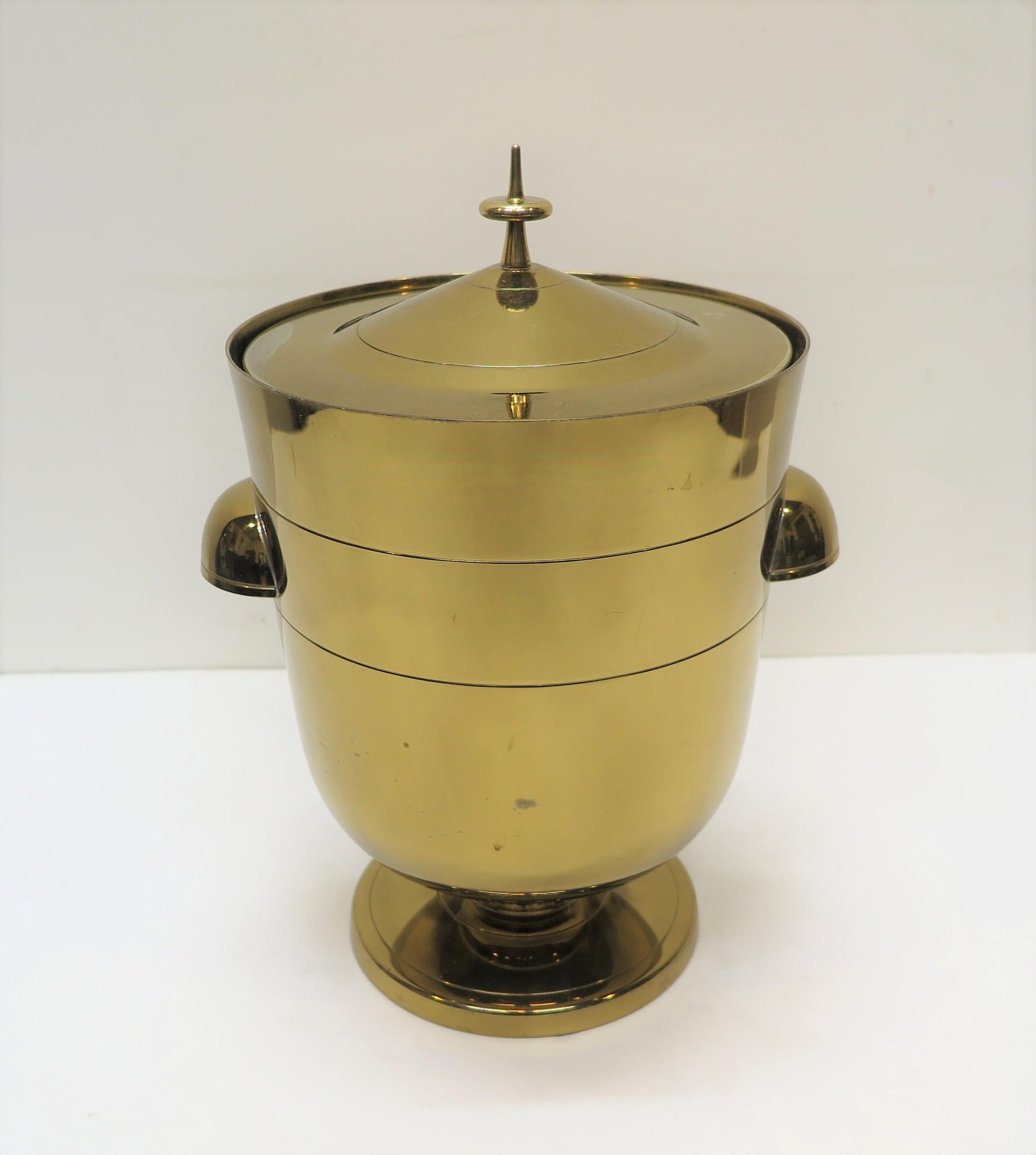 Tommi Parzinger Ice Bucket for Dorlyn Silversmiths. Solid brass in original condition. The original patina has a gold plating with light signs of use, some light surface scuffs show the brass.  Very good condition no dents. 
 
