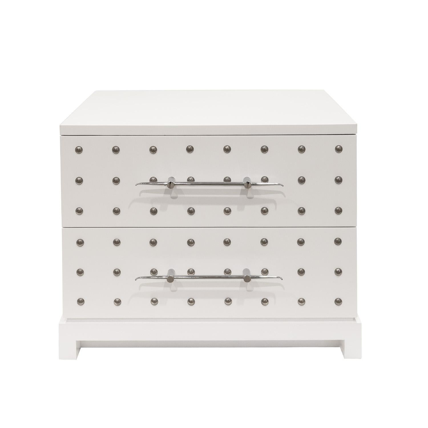Small cabinet/chest/bedside table model 223S with 2 drawers in white lacquered mahogany with chrome studs and exquisite pulls by Tommi Parzinger for Parzinger Originals, American 1981.  This piece is a gem.  Beautifully crafted, it exudes Parzinger