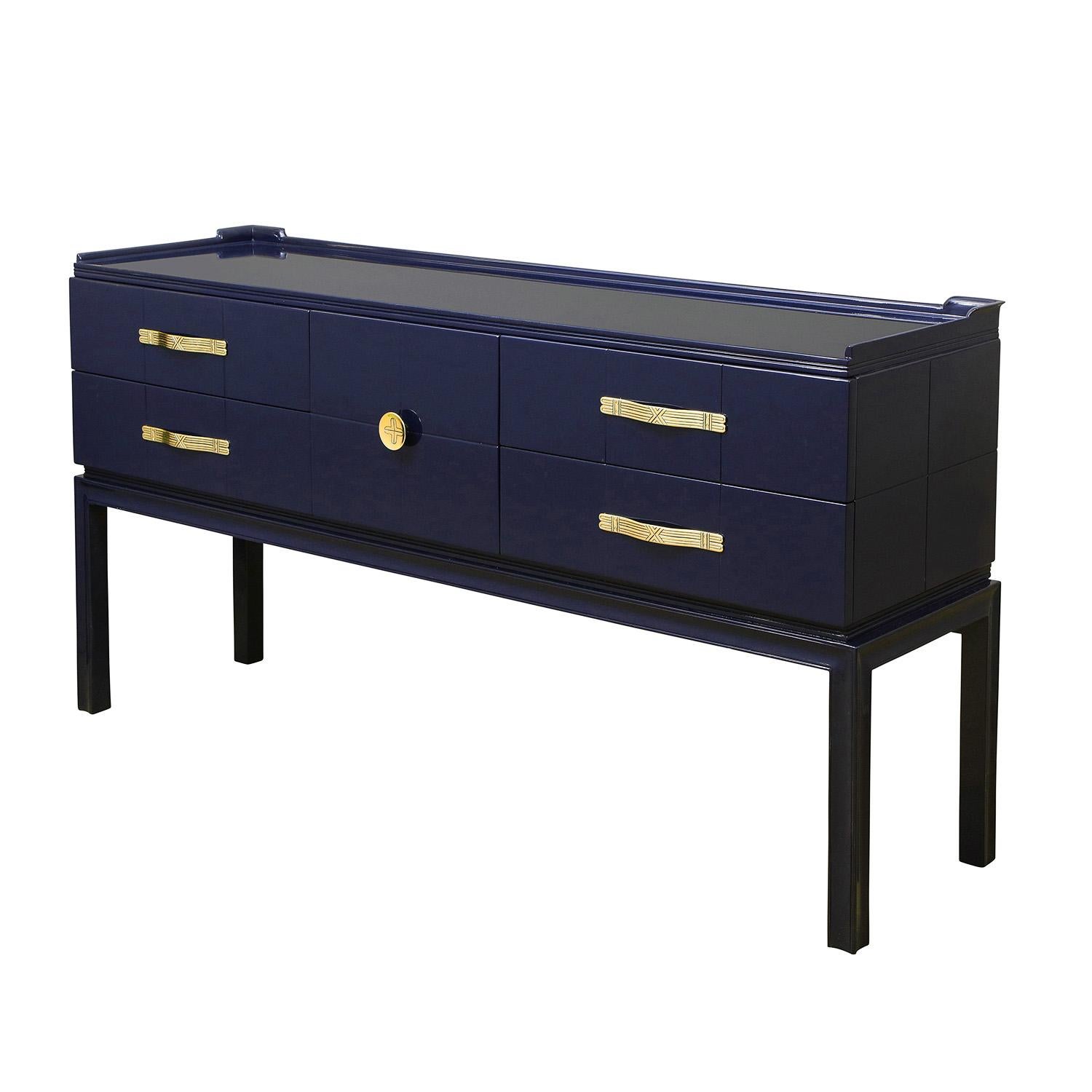 Elegant console/cabinet in high gloss blue lacquer with iconic etched brass hardware and sculpted top edge by Tommi Parzinger for Charak Modern, American 1940's (signed with Charak Modern label in top left drawer).

Lobel Modern has had this piece