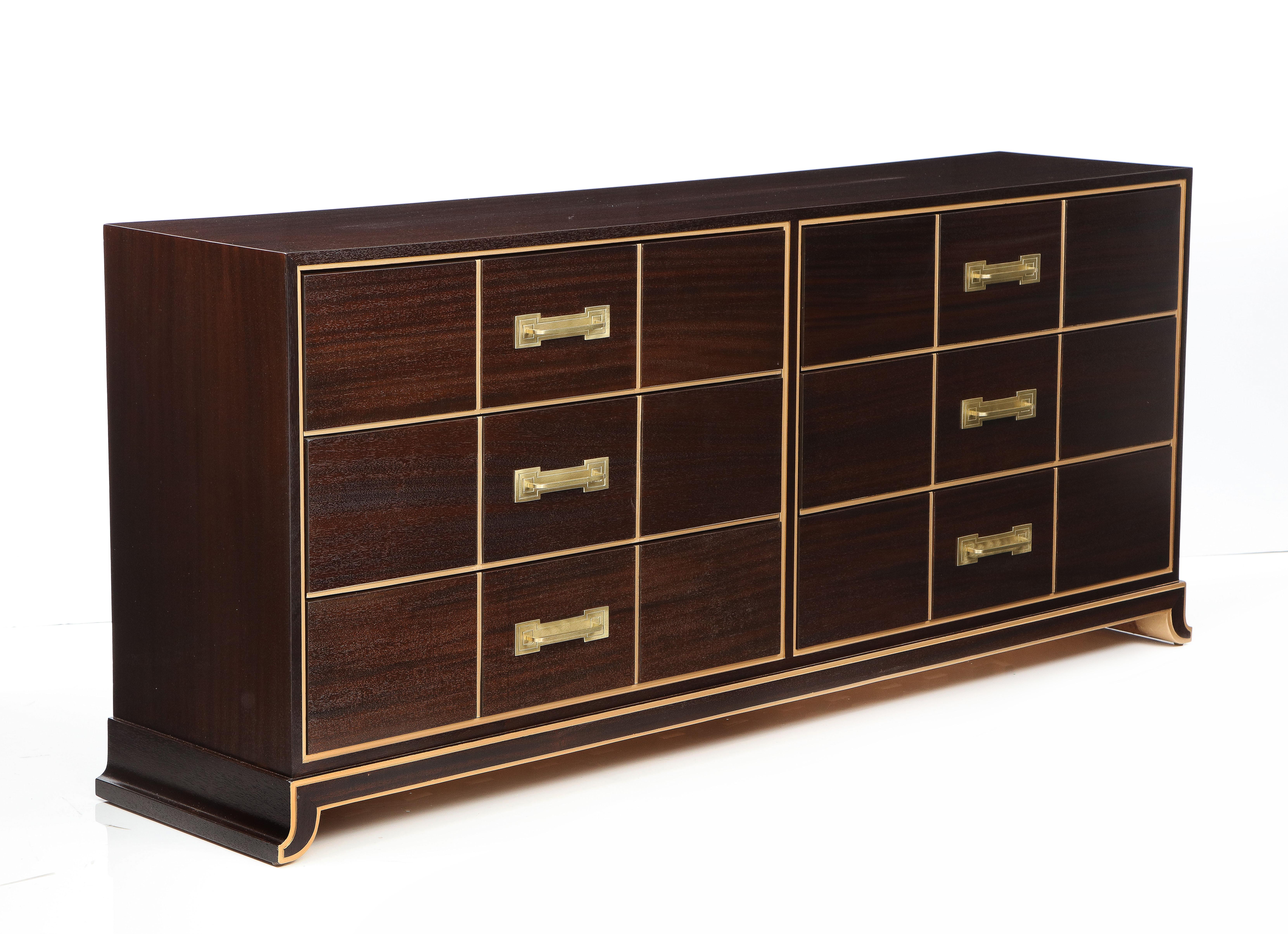 Spectacular mid-century Mahogany dresser designed by Tommi Parzinger. Dresser has 6 ample drawers with brushed brass engraved pulls and carved and gilded stripe detailing. This example exudes the sophistication, sexiness and classicism Parzinger is