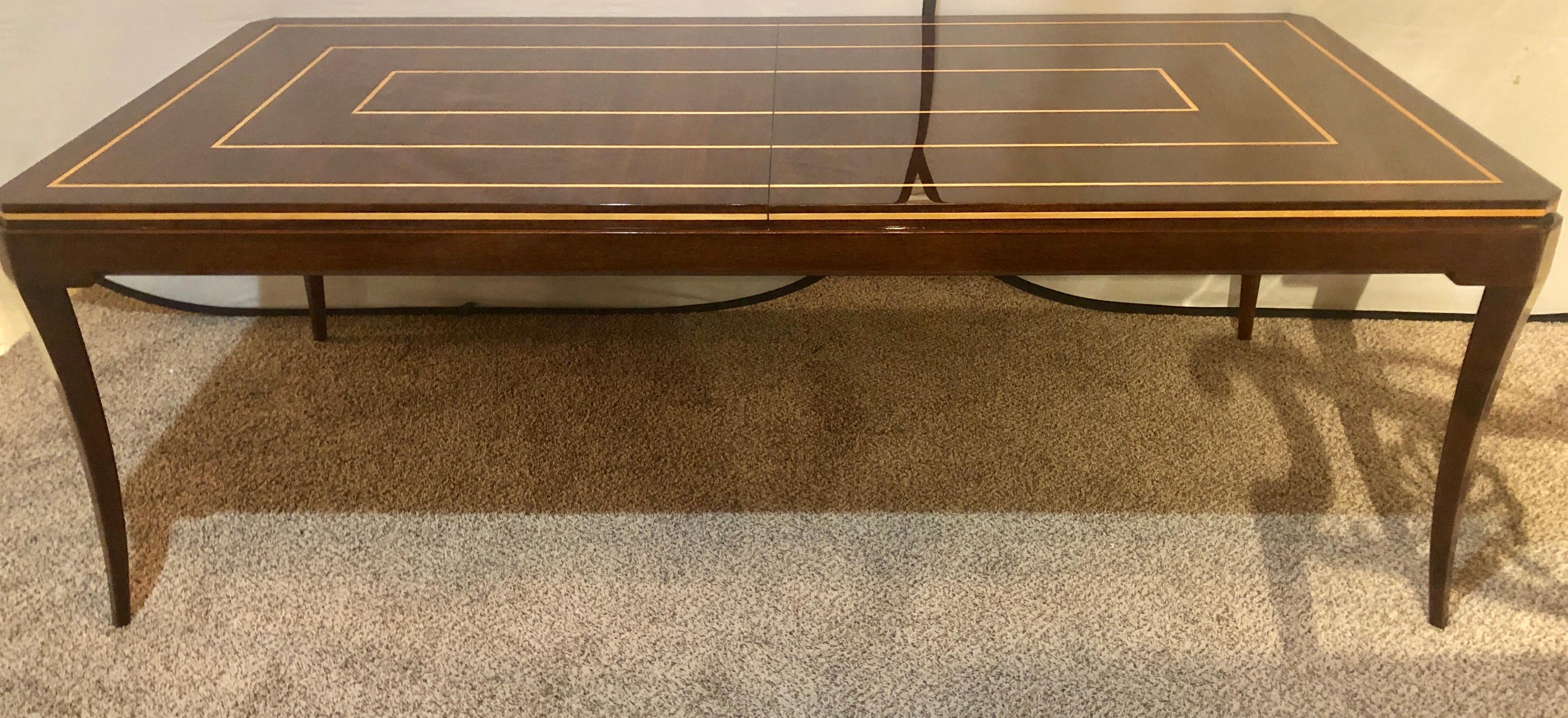 Tommi Parzinger Mid-Century Modern mahogany Charak modern two leaf dining table. This table has the finest finish anyone could possibly ask for. The pristine conditioned mahogany Charak Modern Dining table is simply a show stopper. The rich tones in