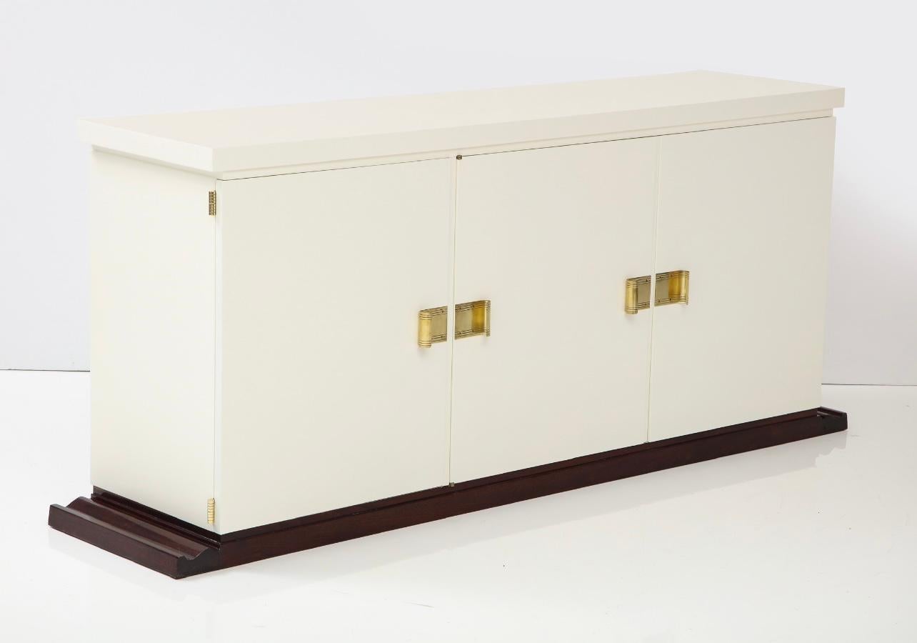 A beautiful original Tommi Parzinger 1960s ivory and mahogany cabinet restored.
