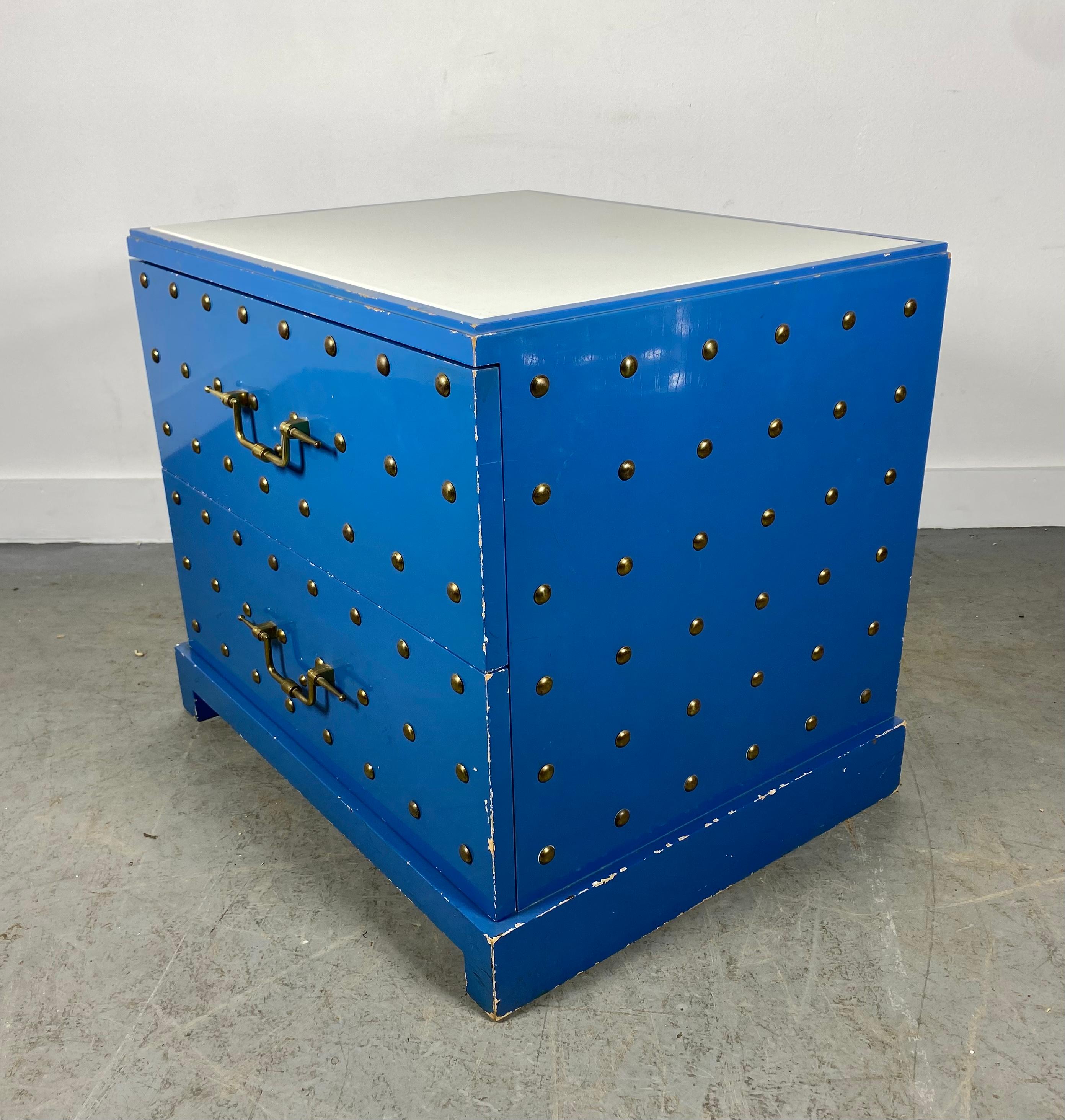 Tommy Parzinger for Parzinger Originals blue lacquered two drawer cabinet.
Some call this a dresser but scale suggests nightstand or bedside chest.
Solid brass round domed studs evocative of hobnail and quintessentially Parzinger refined drawer