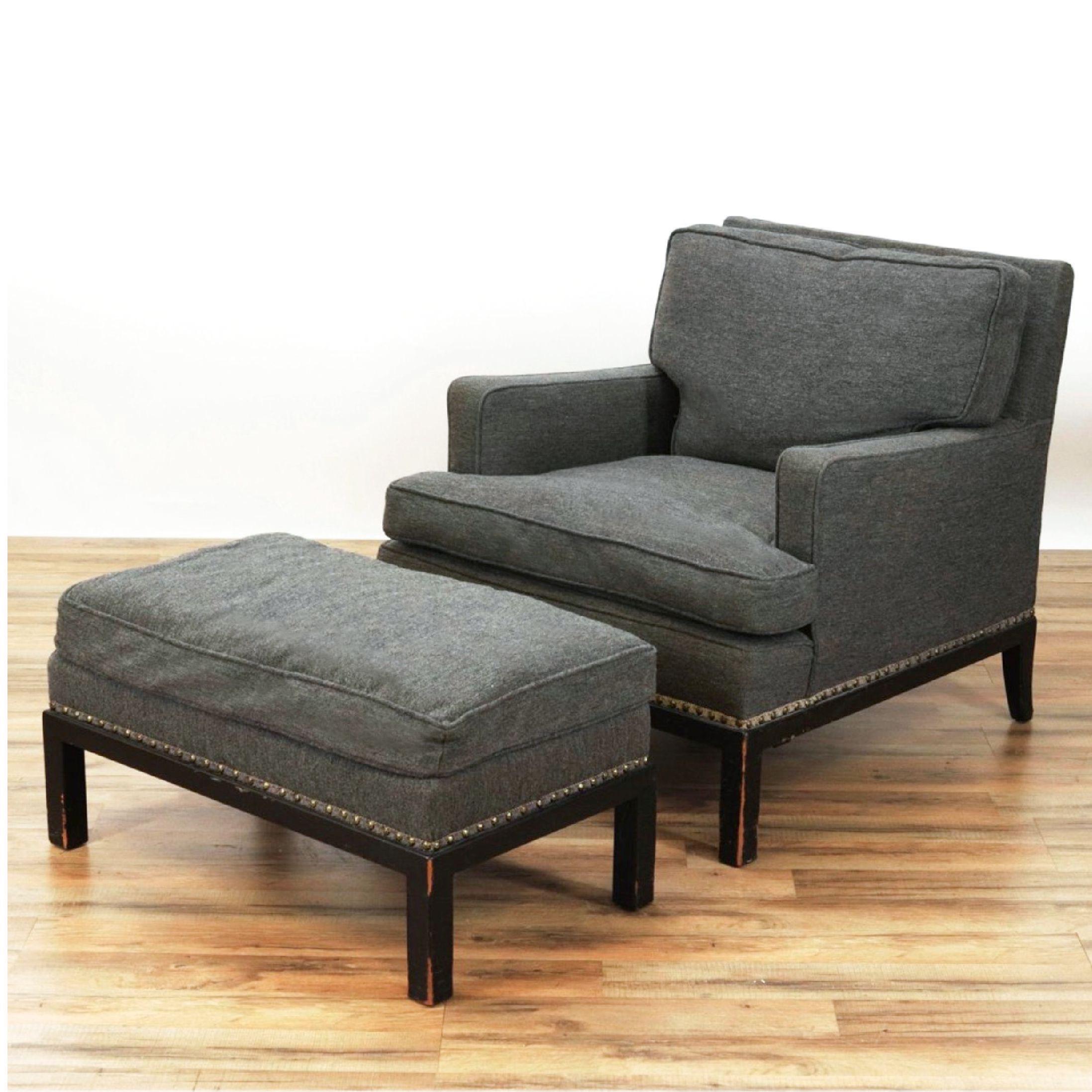 Tommi Parzinger lounge chair and ottoman, ebonized frame, charcoal grey upholstery. Copy of the original purchased receipt included from Parzinger Originals Inc., dated January 15, 1958
 Dimensions: 27