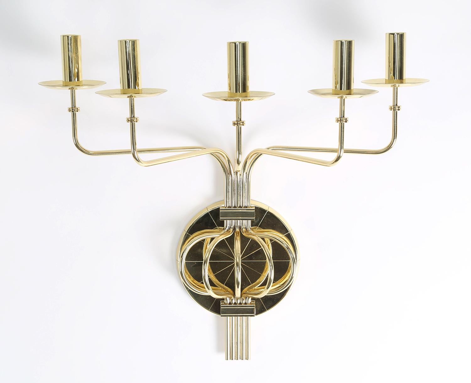 Pair of impressive 5 arm candelabra in polished brass by Tommi Parzinger for Dorlyn Silversmiths, American 1950's. These are just exquisite in person.