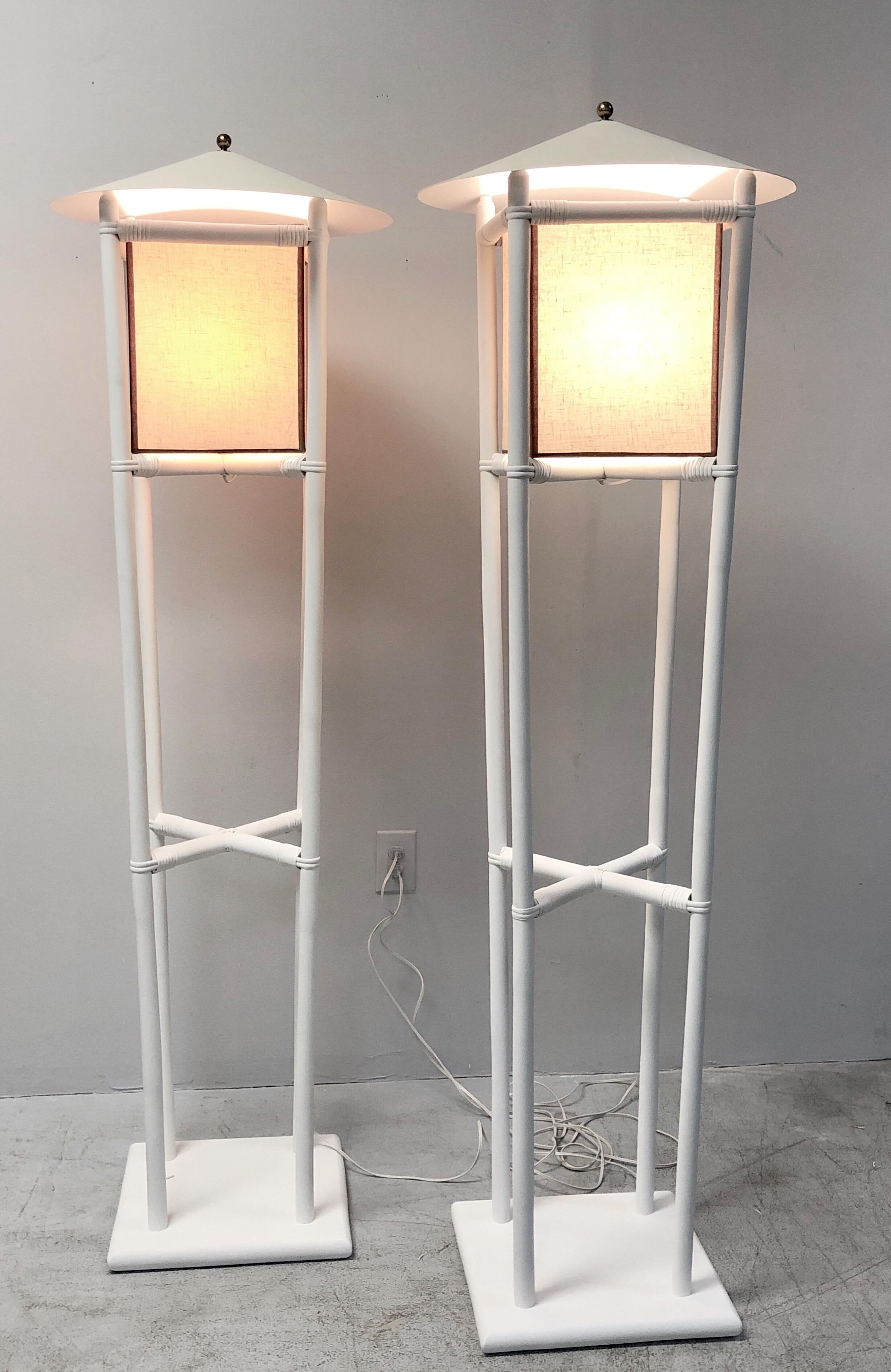 A pair of rarely seen bamboo lamps by Tommi Parzinger, part of the Pavillion collection he designed for Willow and Reed. Bamboo frames with fabric shades and metal diffusers. Refinished in flat white enamel. Original shades, the metal diffusers are