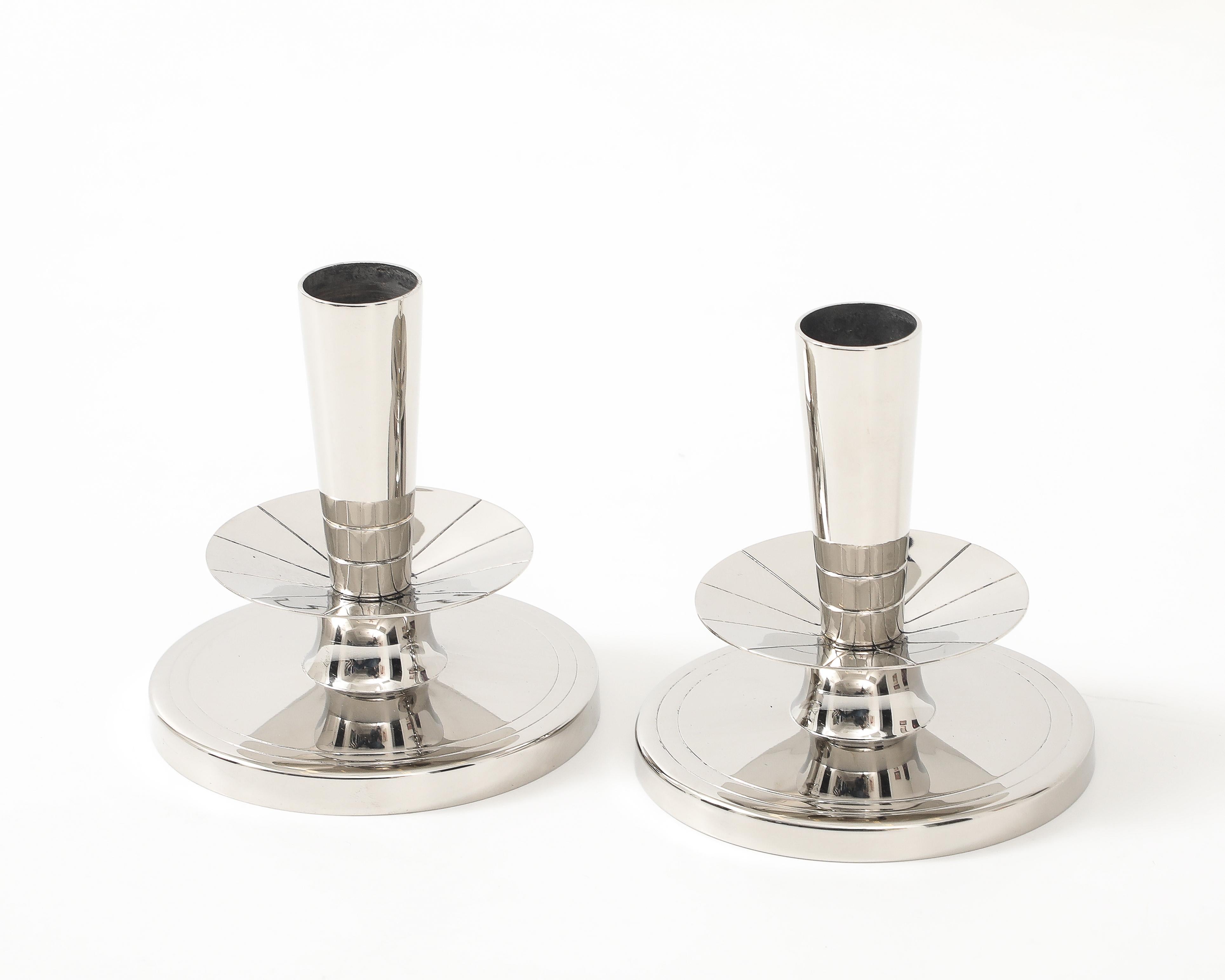 Exquisite pair of round polished nickel candle holders with an engraved band on base, stamped on bottom.