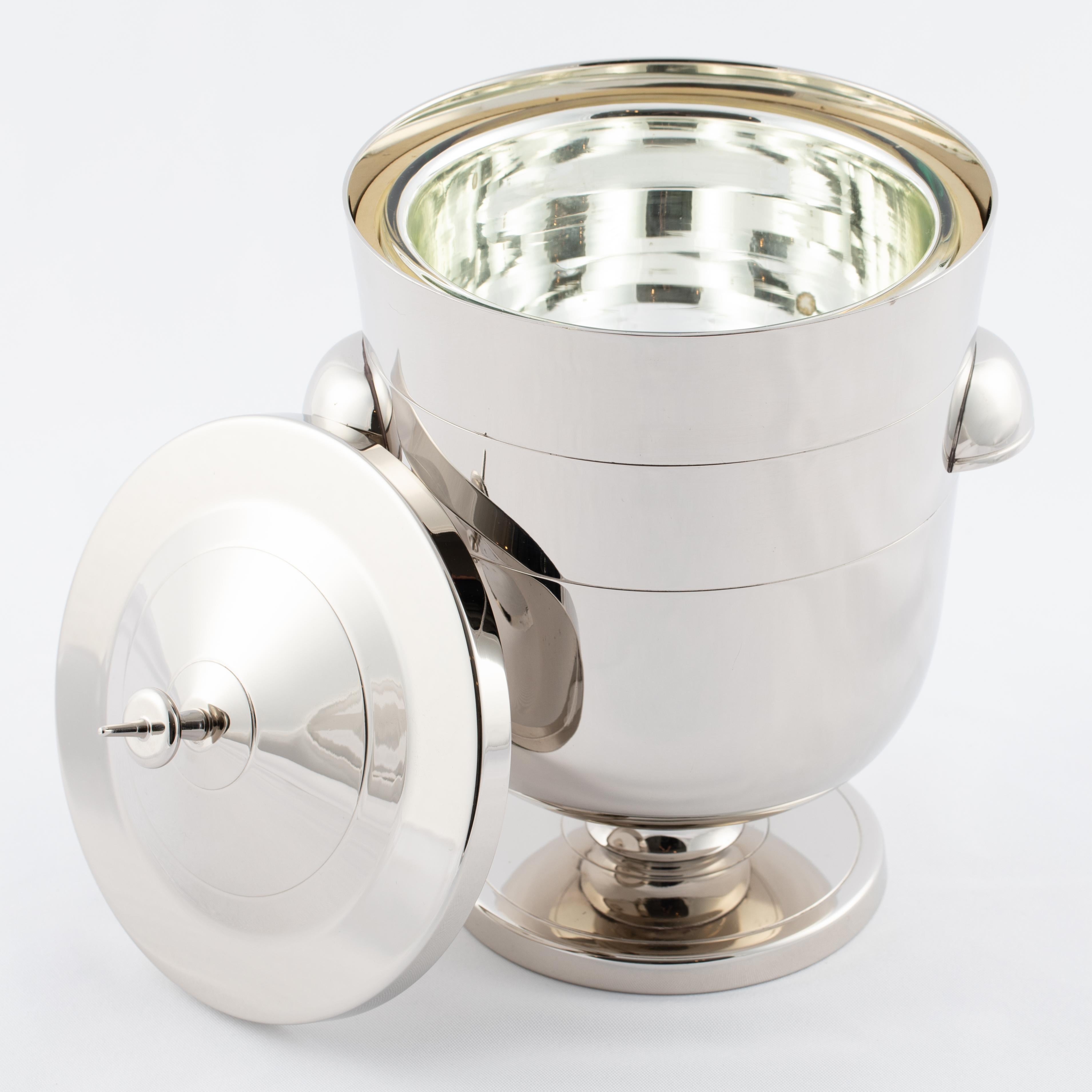 Lovely midcentury ice bucket with incised ring designs by Tommi Parzinger for Dorlyn-Silversmiths. Newly re-plated in polished nickel. Retains original mercury-glass insulated insert. Maker's stamp on underside. 




