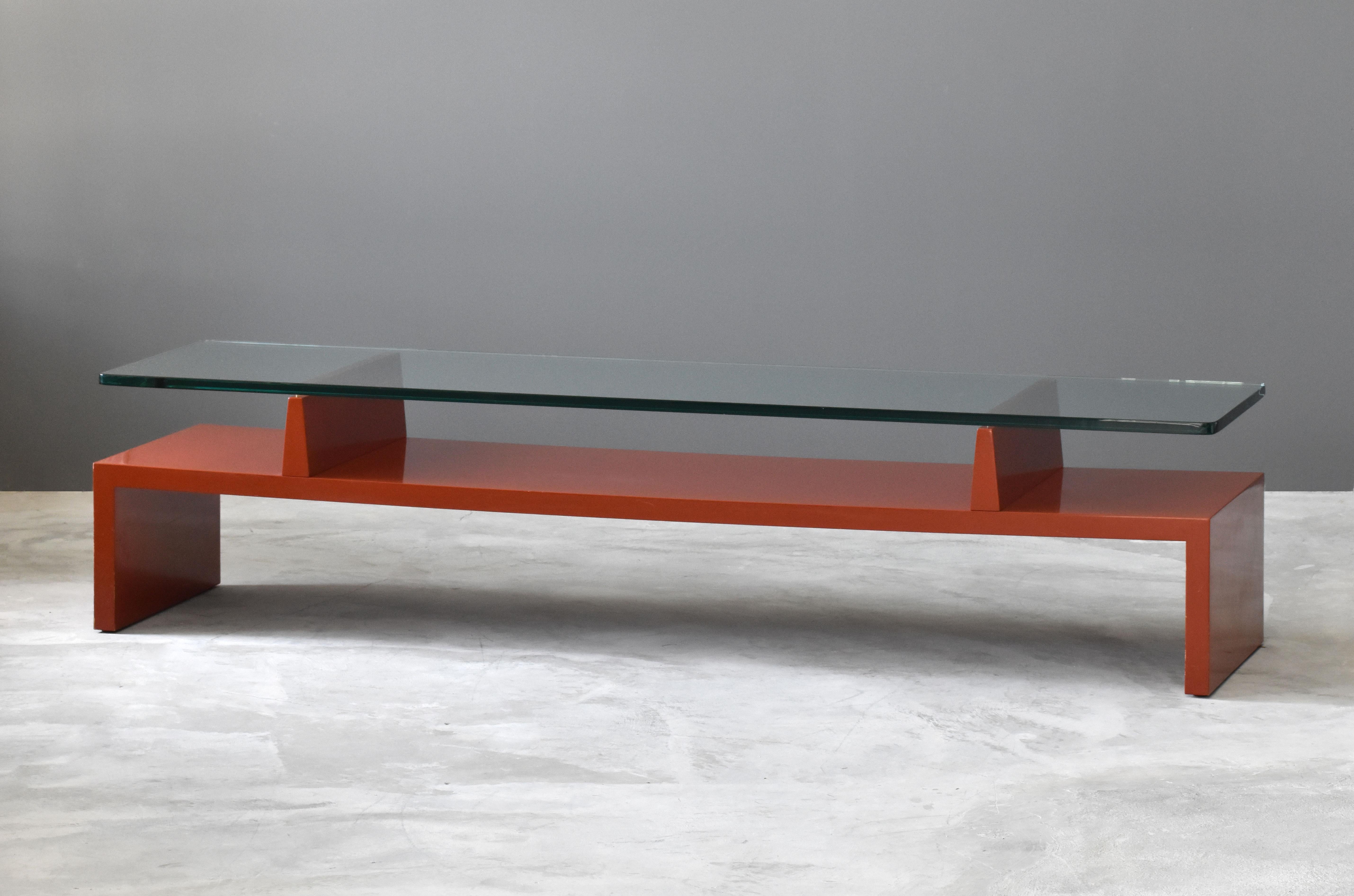 A rare and Minimalist coffee / cocktail table, designed by Tommi Parzinger and produced by his own firm, Parzinger Originals. 

Parzinger manages to enliven a Minimalist form by lacquering it in deep cinnober red, the iconic pigment employed as