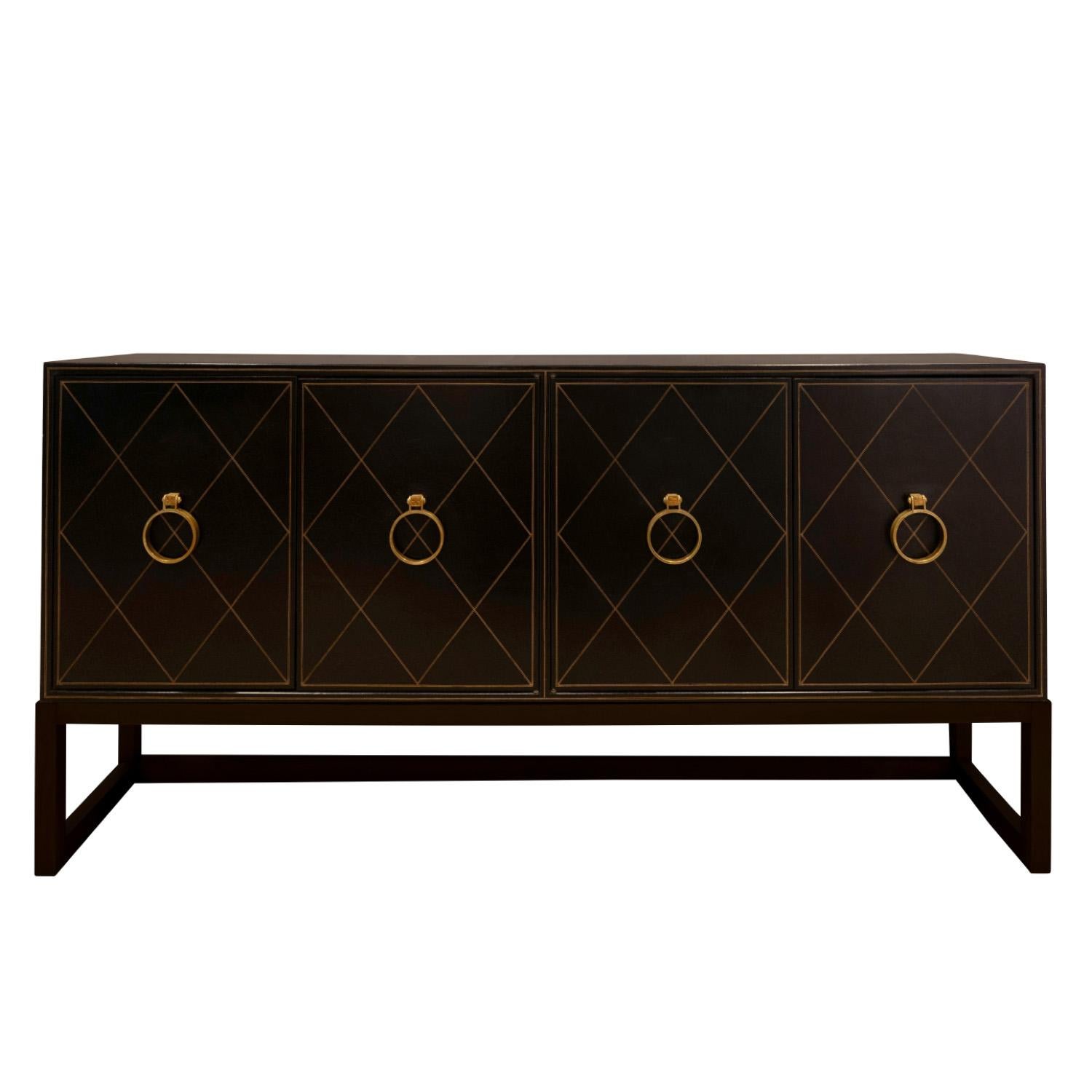 Iconic and rare 4 door credenza model TP 18  with hand-tooled black leather doors and iconic etched brass pulls on ebonized mahogany base by Tommi Parzinger for Charak Modern, American 1940's (signed on back “Charak Modern”). The hand-tooling is