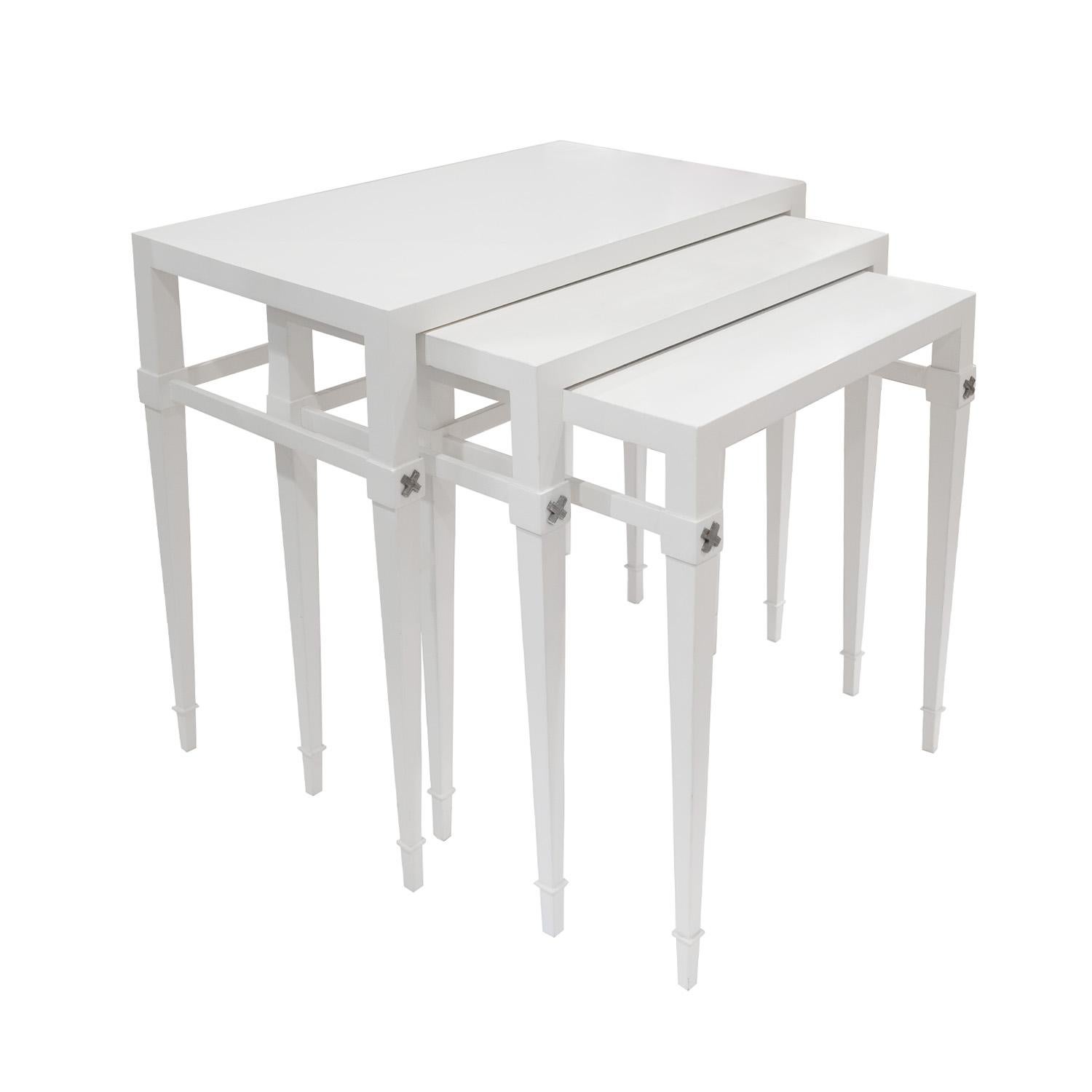 Rare set of 3 nesting tables model M111, beautifully made in white lacquer with etched nickel X accents on the tapering legs by Tommi Parzinger for Charak Modern, American 1940's (signed “Charak Modern” on label on bottom). These tables are