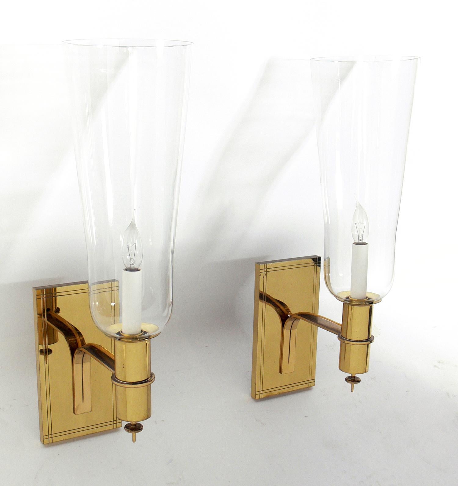 Pair of brass and glass sconces, designed by Tommi Parzinger, American, circa 1950s. They have been rewired and are ready to use.