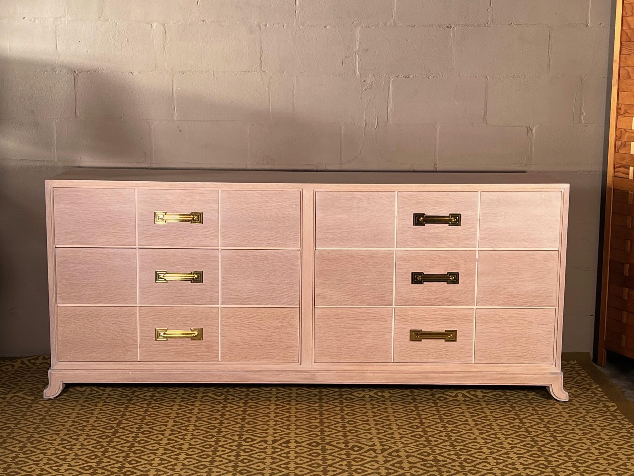A rare six drawer dresser by Tommi Parzinger for Charak Modern ca' 1950's. From original owner. Pickled oak with original, polished and laquered hardware. This piece is elegant and light. The color is flesh white that appears white or more peachy