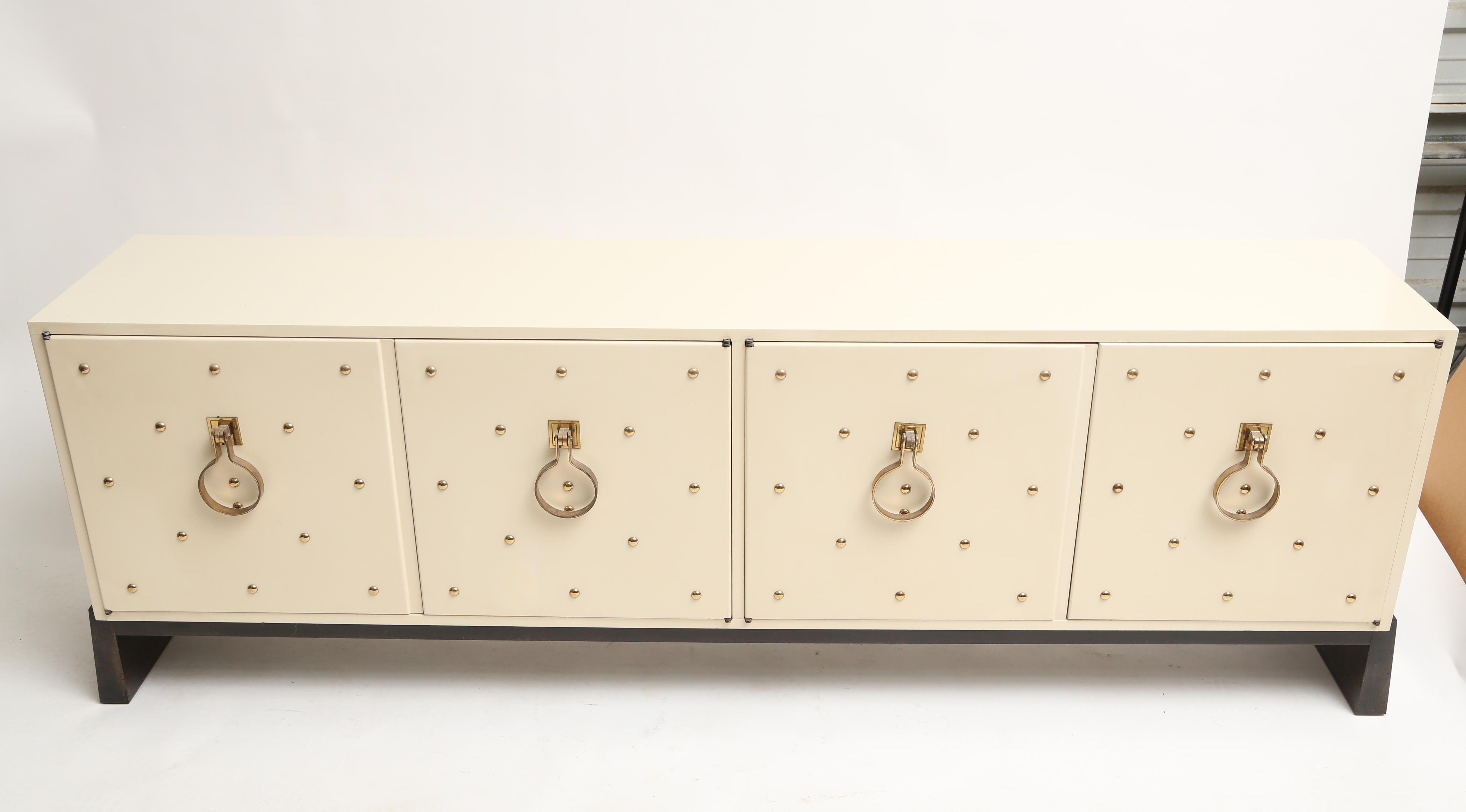 The studded cabinets are one of Tommi Parzinger's signature designs.
This example is in the original surface.
Stamped with the Parzinger mark.
 
