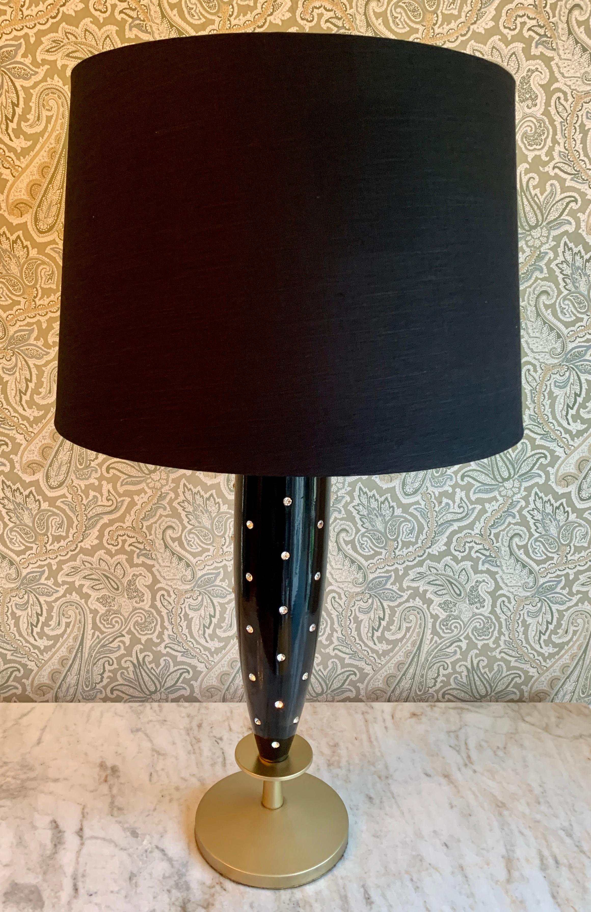 Tommi Parzinger studded lamp with silk shade, this singular lamp is perfectly suited for any individual space, and a compliment to the vanity or dressing area, especially due to the sexy large diamond like studs in the black lacquer base.

The